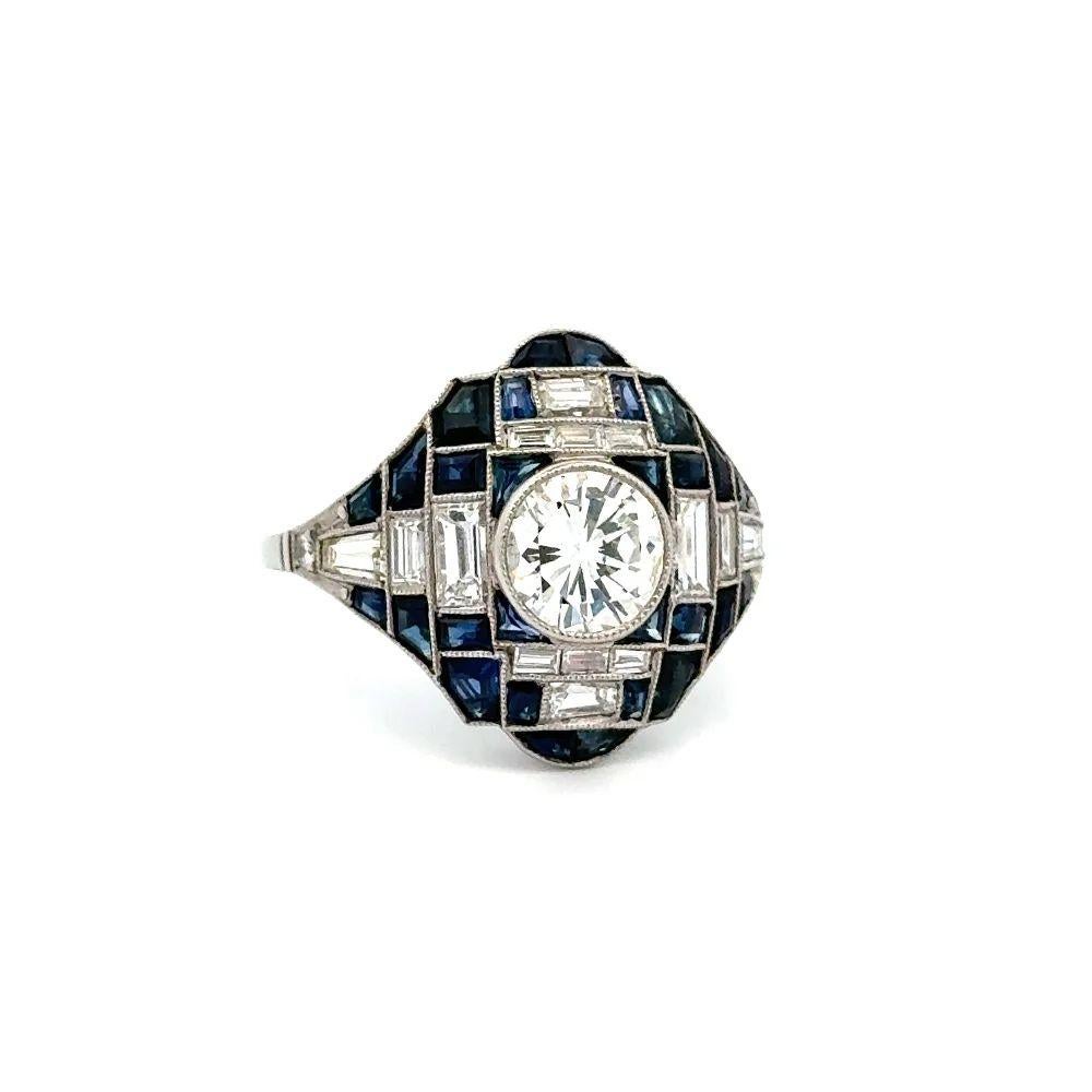 Simply Beautiful! Finely detailed Show Stopper Diamond and Blue Sapphire Statement Platinum Cocktail Ring. Centering a securely nestled Hand set 1.01 Carat Round Brilliant Cut Diamond. Surrounded by Blue Sapphires, weighing approx. 1.56tcw and