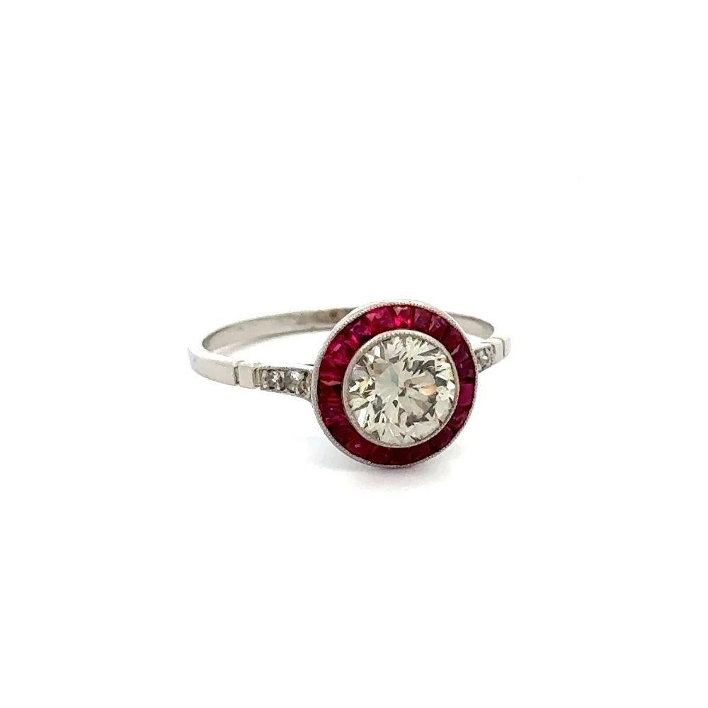 Simply Beautiful! Finely detailed Show Stopper Diamond and Ruby Vintage Platinum Cocktail Ring. Centering a securely nestled Hand set 1.12 Carat Round Brilliant Cut Diamond. Surrounded by a Halo of Rubies, weighing approx. 0.88tcw and accented by 3