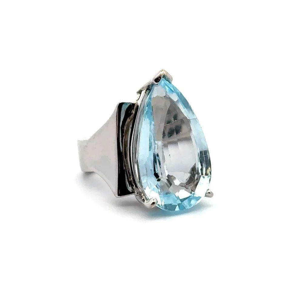 Simply Beautiful! Vintage Oscar Worthy Pear Blue Topaz Solitaire Cocktail Gold Ring. Centering a securely Nestled Hand set Impressive Pear Blue Topaz, weighing approx. 20 Carats. Finely Hand-crafted 14K White Gold Heavy Wide Shank mounting. Ring
