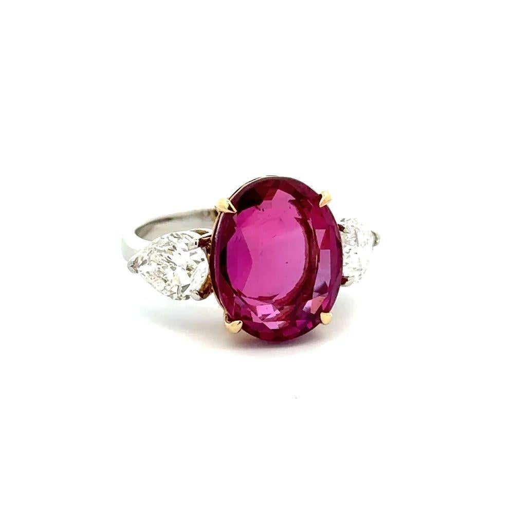Simply Beautiful! Finely detailed Fabulous Show Stopper Oval Burma Ruby and Diamond Statement Platinum Ring. Centering a securely nestled Hand set Oval Pinkish-Red Burma Heated Ruby Gemstone GRS, weighing approx. 9.37 Carats. Accented either side by