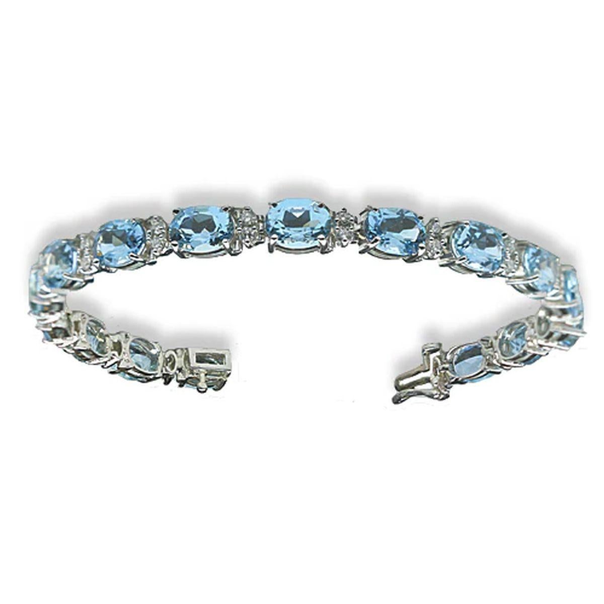 Simply Beautiful! Elegant and finely detailed Vintage Oscar Worthy Deep Intense Blue Aquamarine and Diamond Gold Bracelet. Hand set with 16 Oval Aquamarine I/F High Quality Gemstones, weighing approx. 17.96tcw. Inter-spaced with Round Brilliant-cut