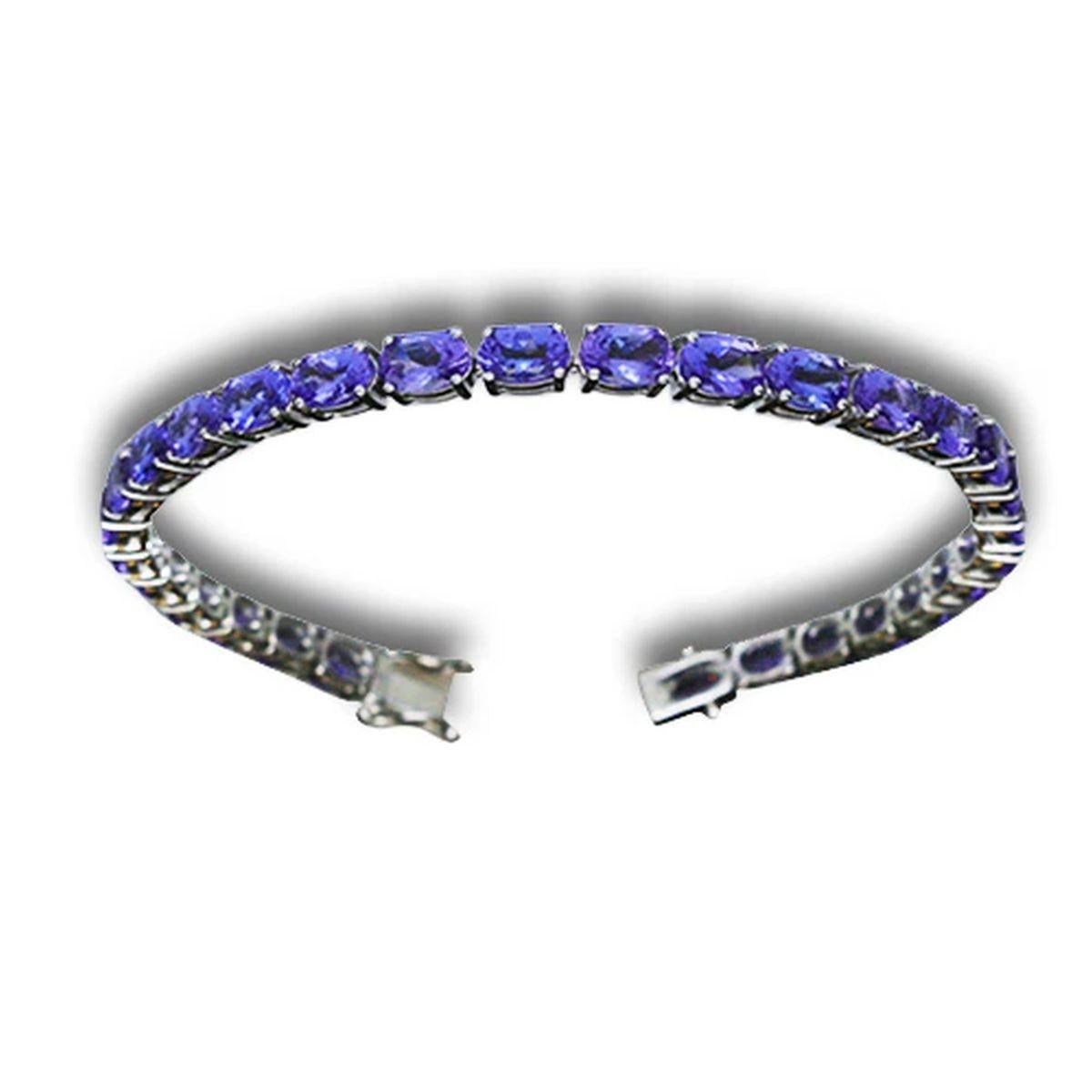 Simply Beautiful! Stylish and finely detailed Vintage Oscar Worthy Tanzanite and Diamond Gold Bracelet. Securely Hand set with 29 Oval Blue/Violet Tanzanite I/F High Quality Gemstones, weighing approx. 12.80tcw. Securely Hand crafted in 14K White