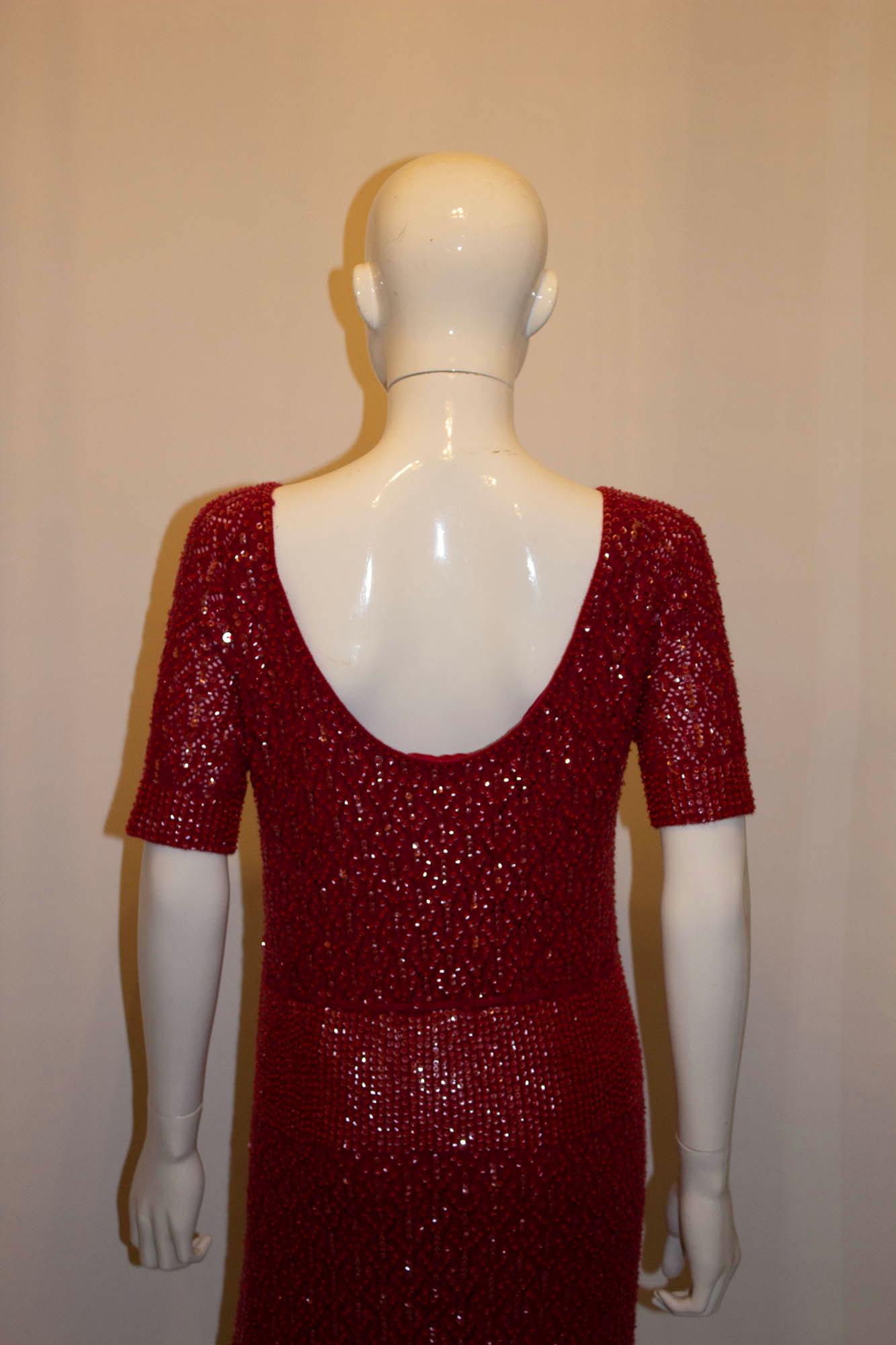 A chic and easy to wear  vintage cashmere , bead and sequin dress. The dress is in a stunning red colour and is fully lined. It has gathering at the waist , a round neckline ,  and low back. 
Measurements; Bust 37'', length 43''
