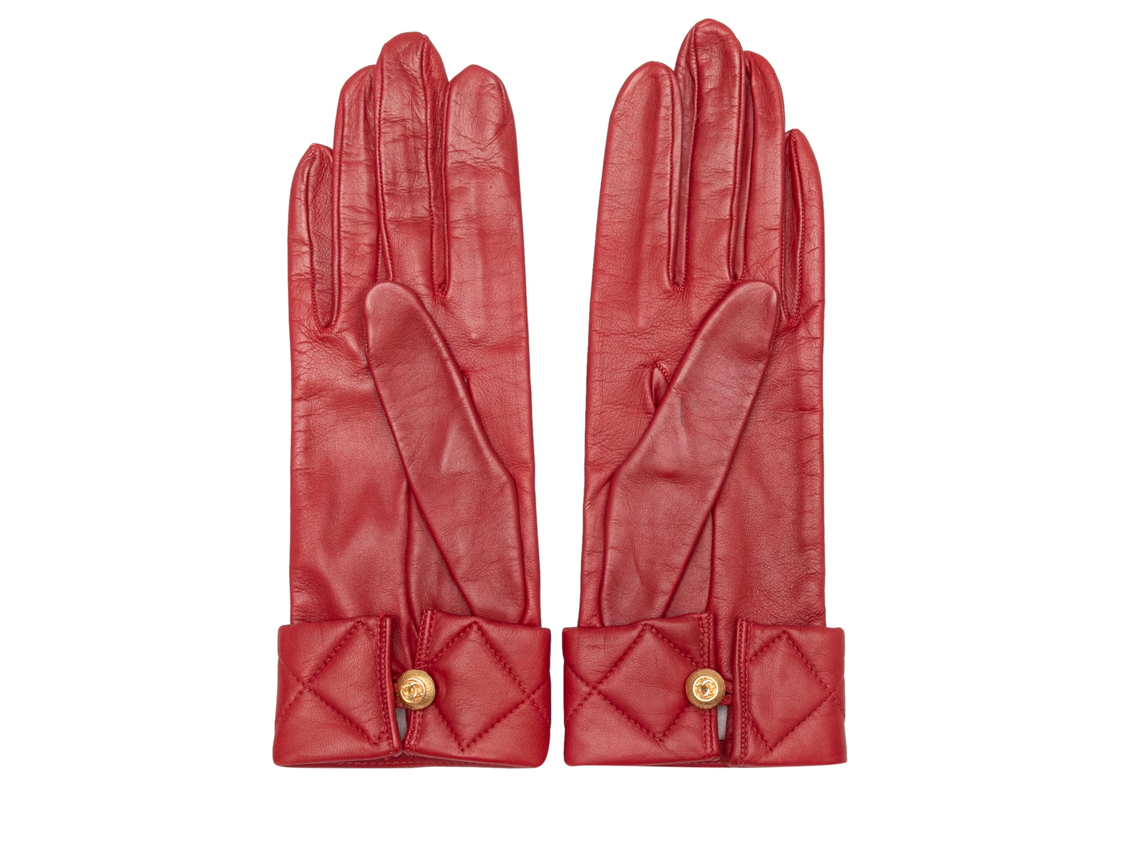 Vintage red leather gloves by Chanel. Quilted cuffs. Gold-tone button closures at wrists. 3.25