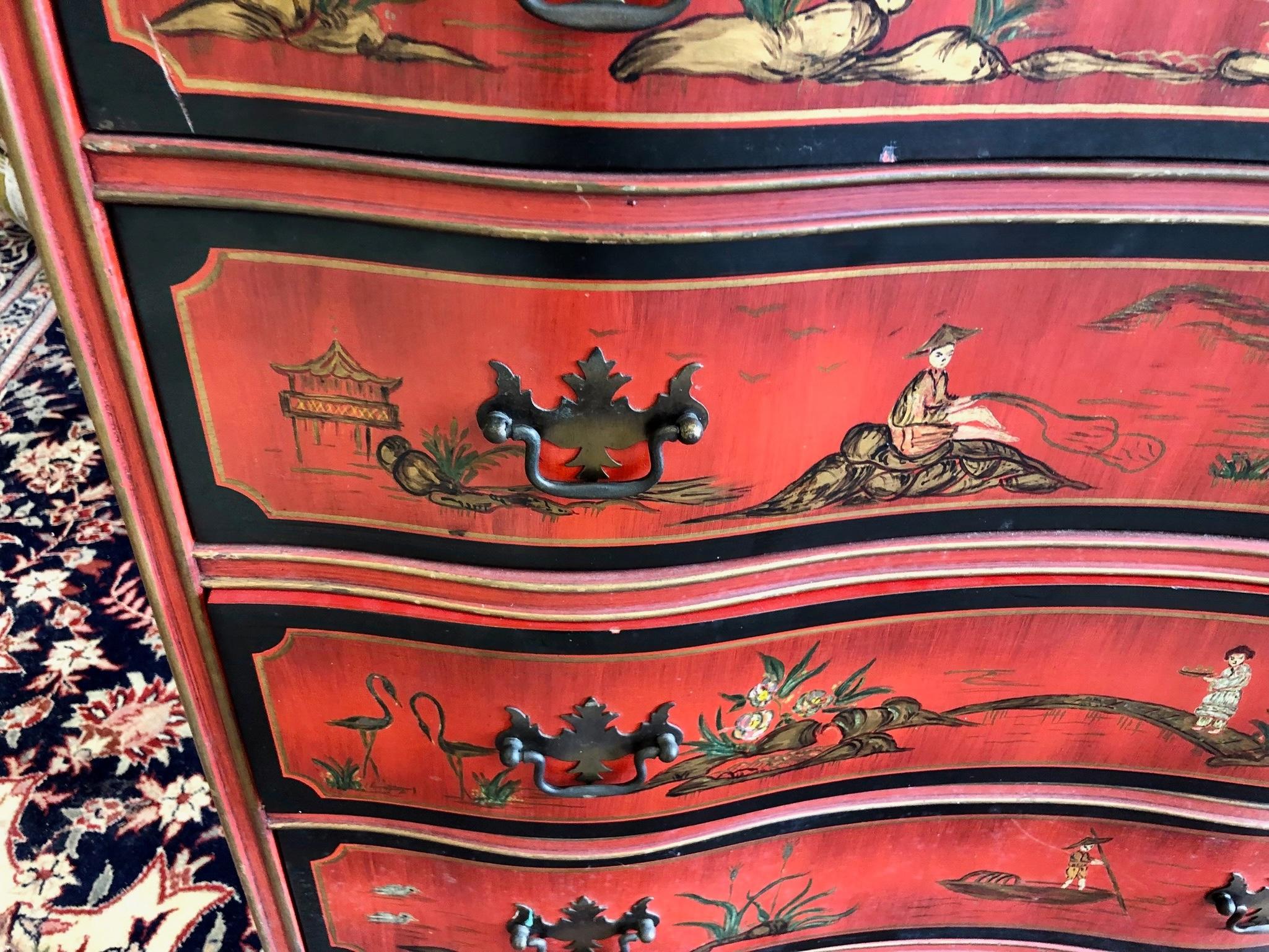 Vintage Red Chinoiserie Bachelors Chest with serpentine front and black gold embossed leather top
Serpentine front with a vibrant red background and decorated with painted scenes of Chinese daily life. Drawers operate freely and open with brass