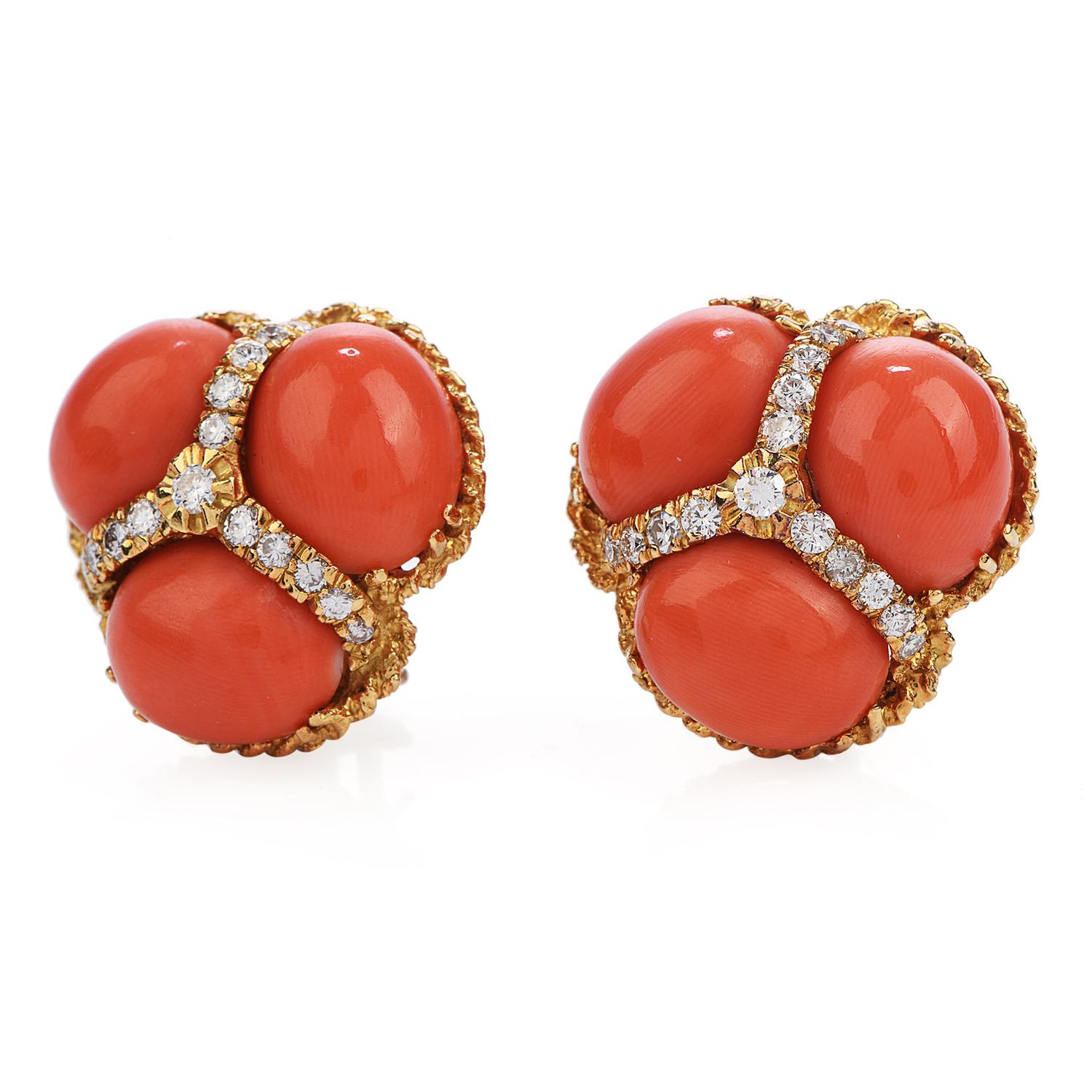 These trending vintage earrings are crafted in finely textured 18K yellow gold, each set with three oval shape cabochon genuine natural red Coral measuring 12mm x 9mm. Corals are separated by natural genuine diamonds weighing approx. approx.