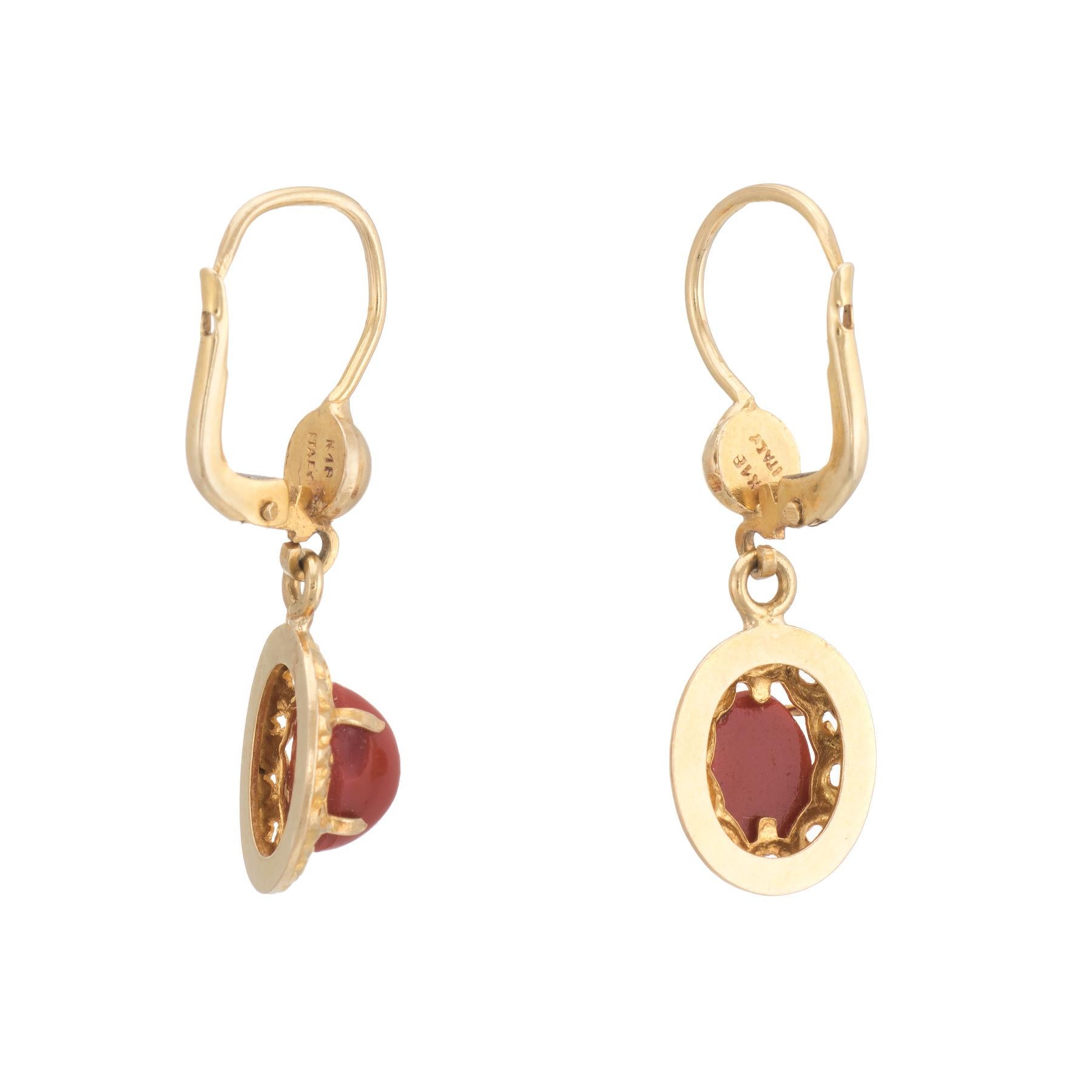 Elegant pair of vintage red coral drop earrings, crafted in 18k yellow gold. 

Cabochon cut red coral measures 8mm x 6mm (estimated at 1.25 carats each - 2.50 carats total estimated weight). The coral is securely set into four pronged mounts.