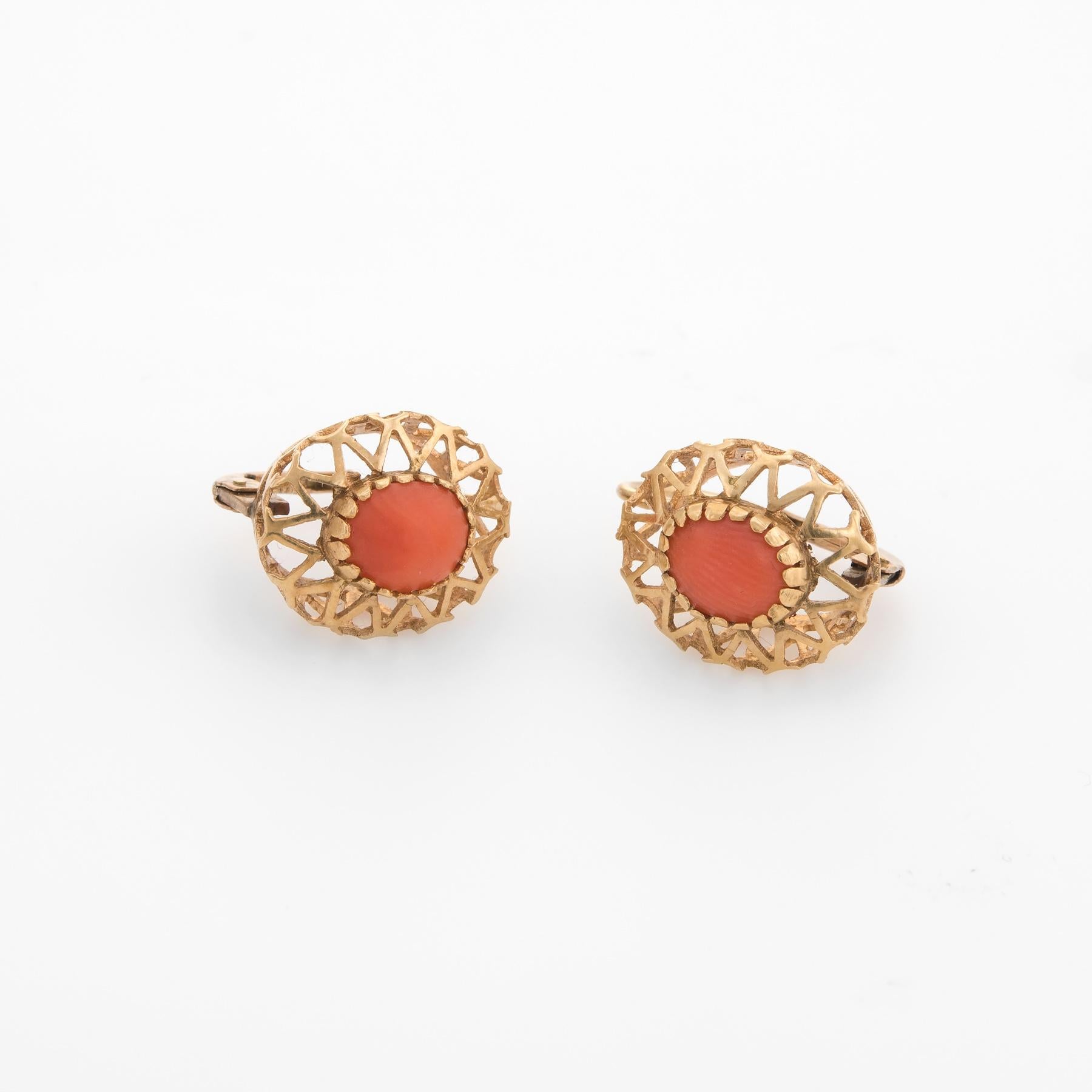 Elegant pair of vintage Mediterranean red coral earrings (circa 1950s to 1960s), crafted in 10k yellow gold. 

Cabochon cut red coral measures 7.5mm x 6mm (estimated at 1 carat each - 2 carats total estimated weight). The coral is in excellent