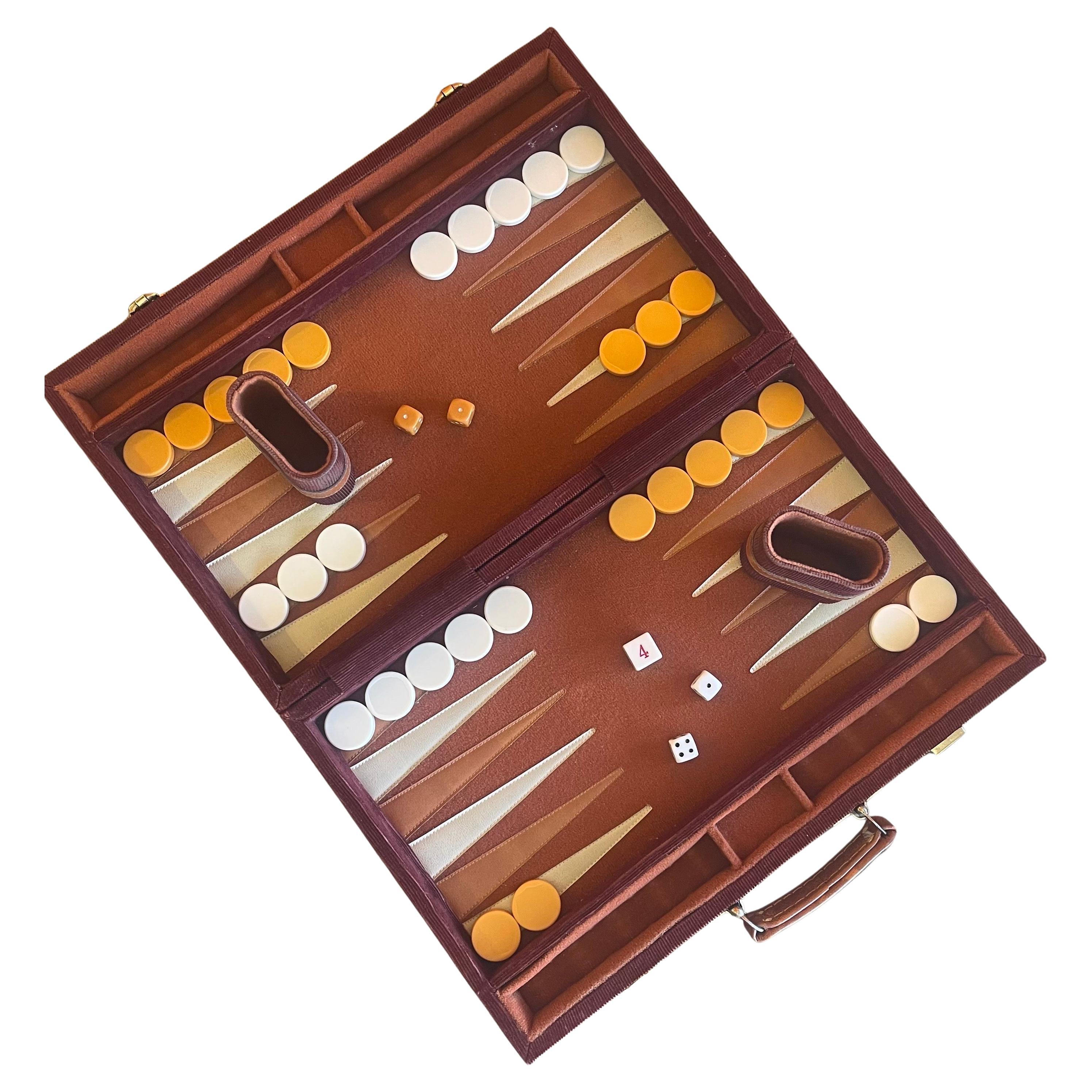 Vintage corduroy and bakelite backgammon set, circa 1970s. Set is complete with a foldable case / board with red corduroy fabric, 30 bakelite checkers (white and butterscotch in color, 1.25