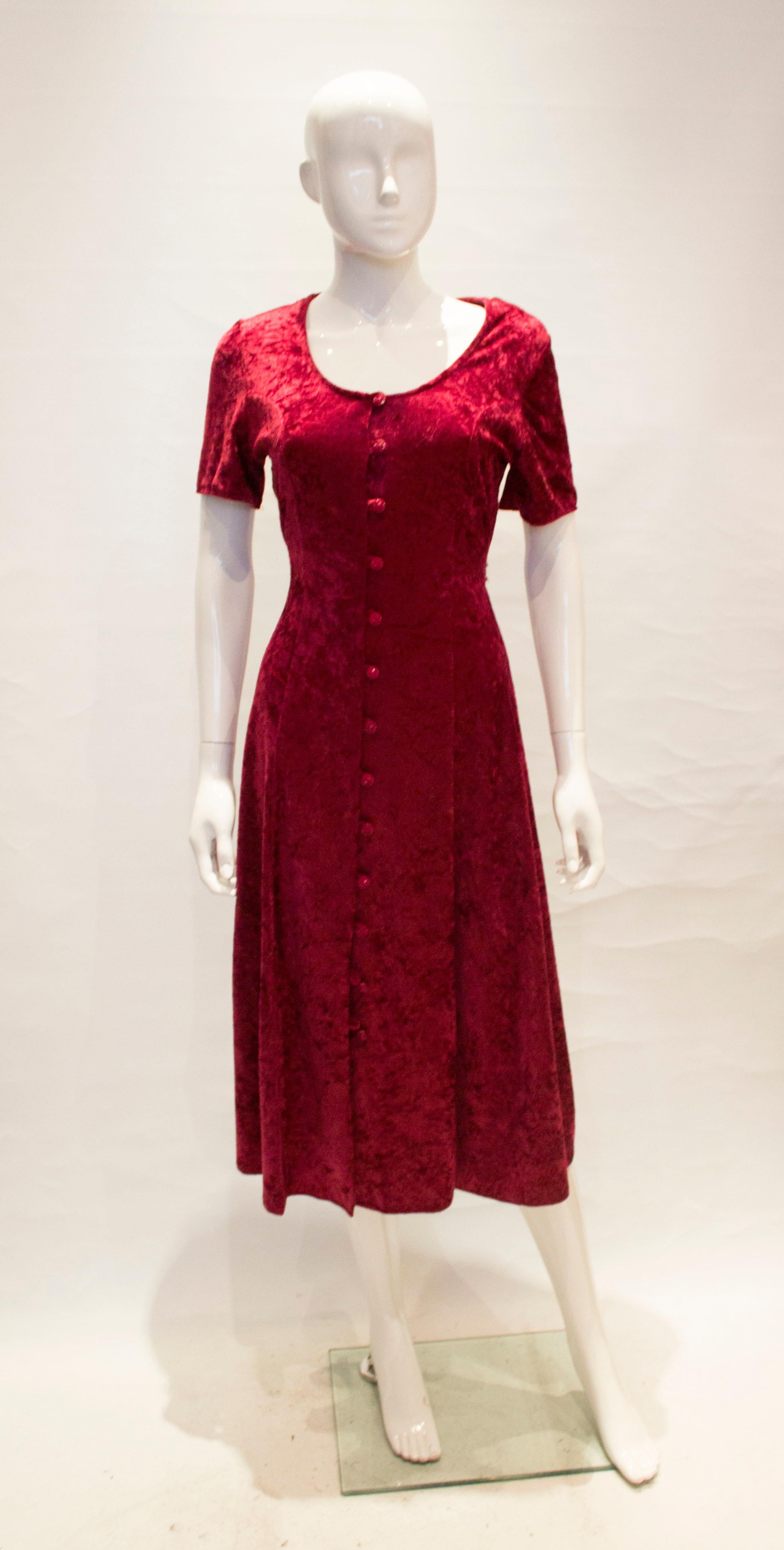 A great dress for the party season. The dress has a scoop neckline, button front opening and self fabric tie back belt. There are four , 13'' slits, along the hem, good for dancing.