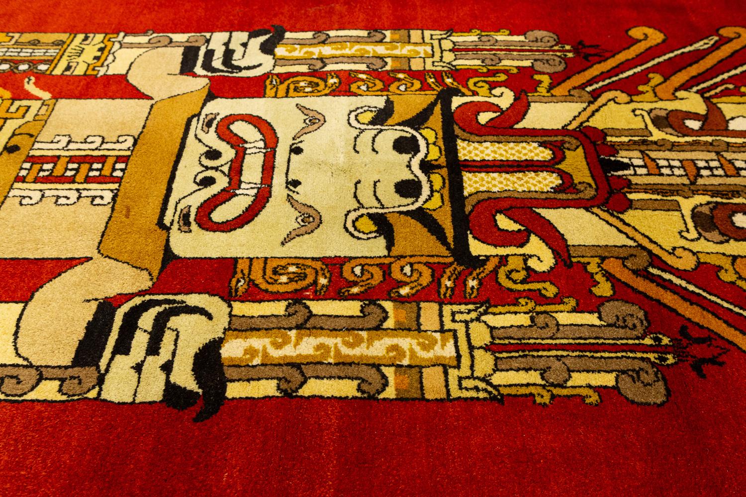 This is a vintage gallery size European rug woven circa 1950 - 1970 and measures 330 x 150CM in size. The unique design of this rug takes inspiration from the ancient Mayan Mexican culture and the main figure is one of their gods. This rug also has