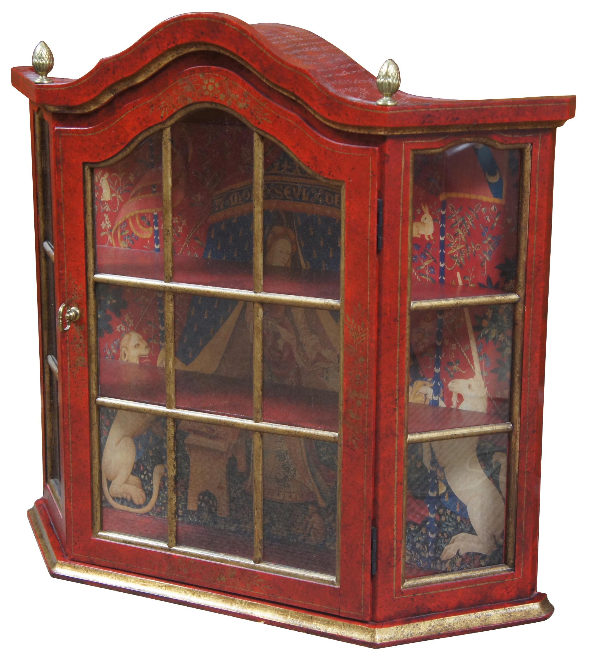 Vintage, circa 1970s. wall curio cabinet or display case. Features traditional styling with red and gold distressed paint, glass paneled door and acorn finials. Interior is lined with a Heraldic or Victorian scene. Measures: 22