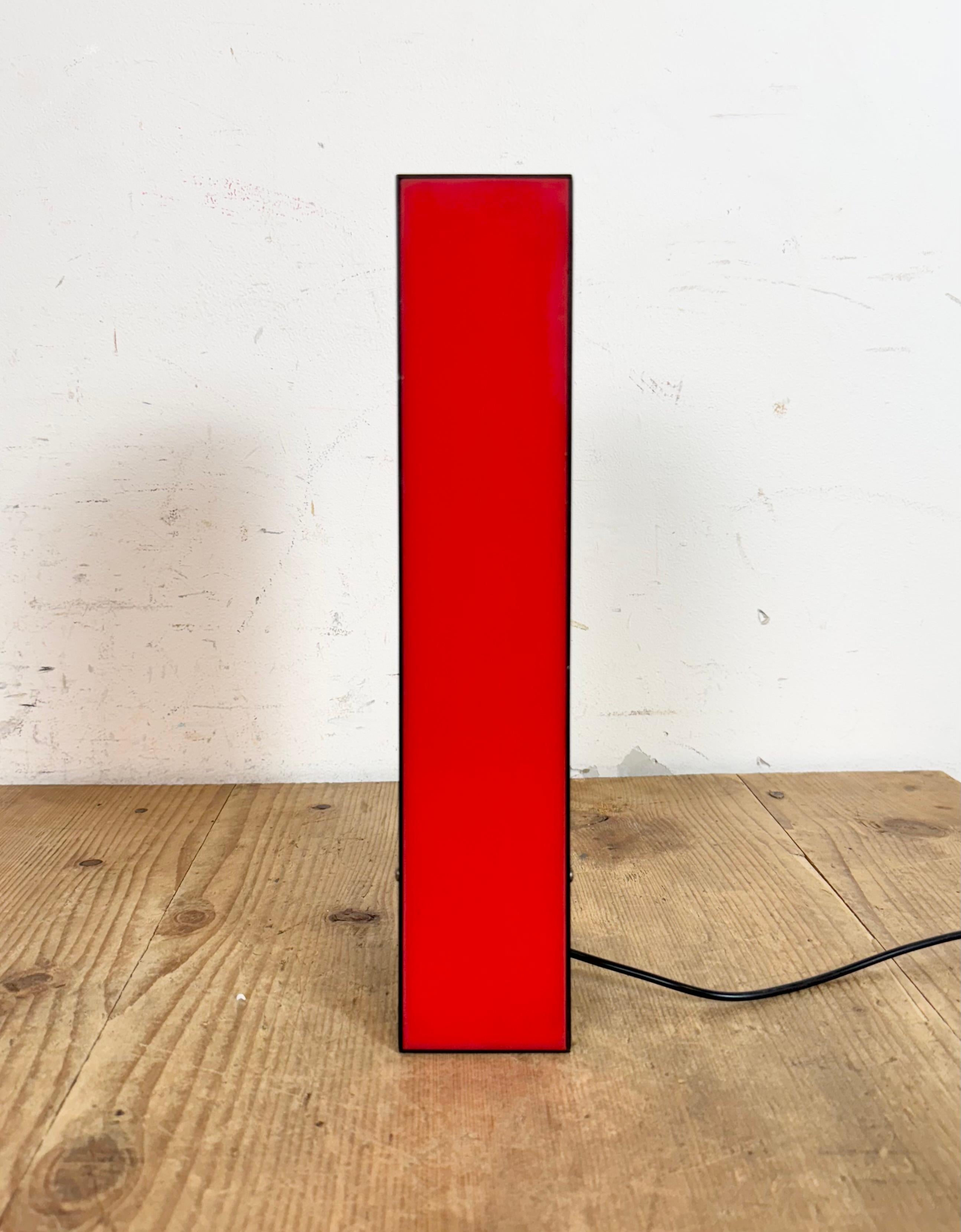 This vintage industrial red illuminated letter I  was made in Italy during the 1970s and comes from an old advertising banner from an old carpet shop in Torino. It features a black iron frame with red plastic writing. It is equipped with a LED