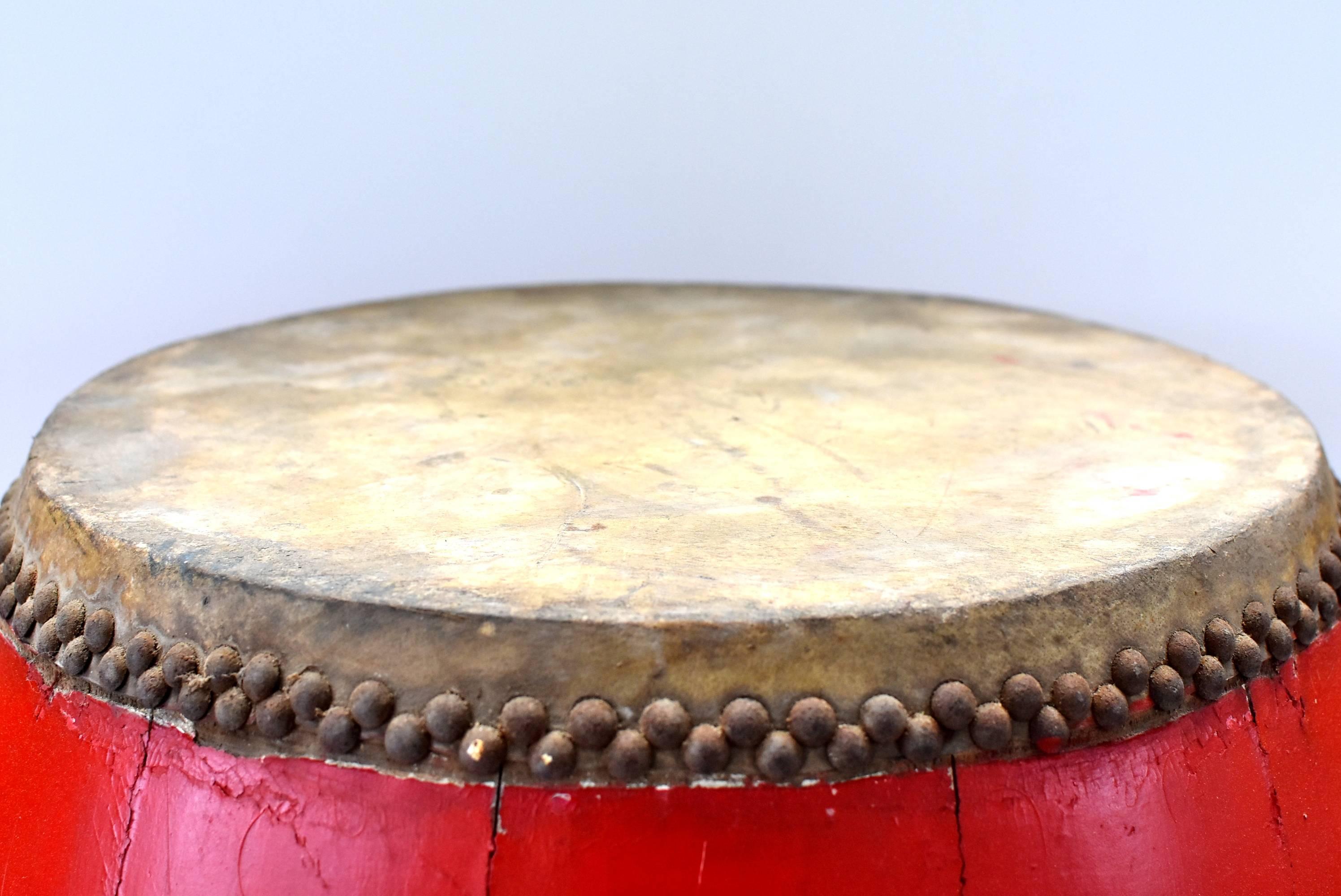 A beautiful, 20th century red lacquered Chinese drum. All original leather top and bottom, iron nails. Gorgeous brilliant red lacquer. A wonderful piece that can be used in any interior as a wonderful piece of accessory or a side table.