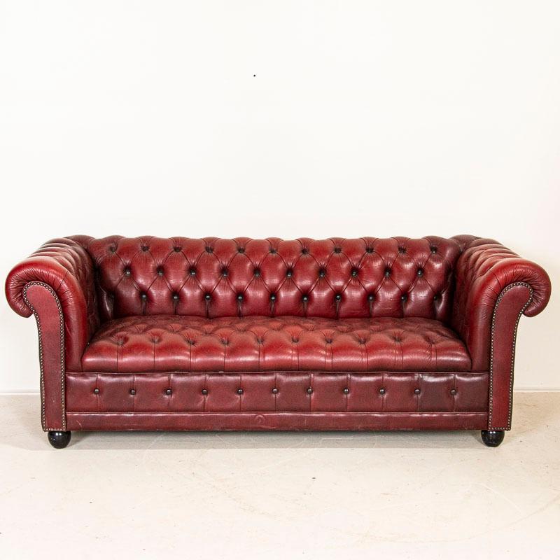 Vintage Chesterfield sofas and chairs are highly sought after today, so this set of red leather sofa and club chair is a fun find. Take a look at the close up photos to appreciate the tufted backs, heavy rolled arms and traditional nailheads. Some