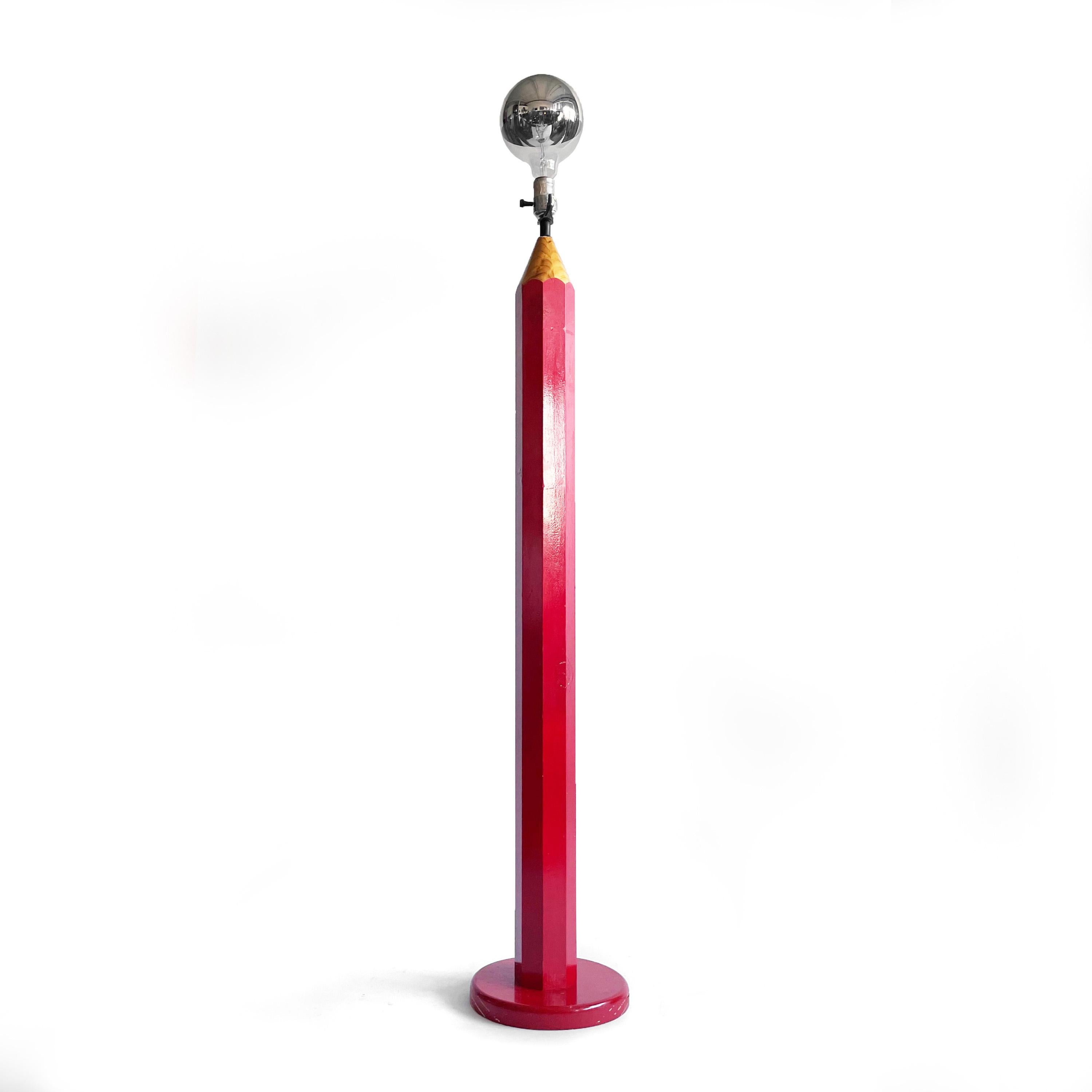 This vintage red Lightolier pencil shaped floor lamp is fun and brings flair to any room. Likely from the 1970s, it has a red painted base with wood tip and brass socket. Looks great with a frosted or mirrored light bulb or with a shade that clips