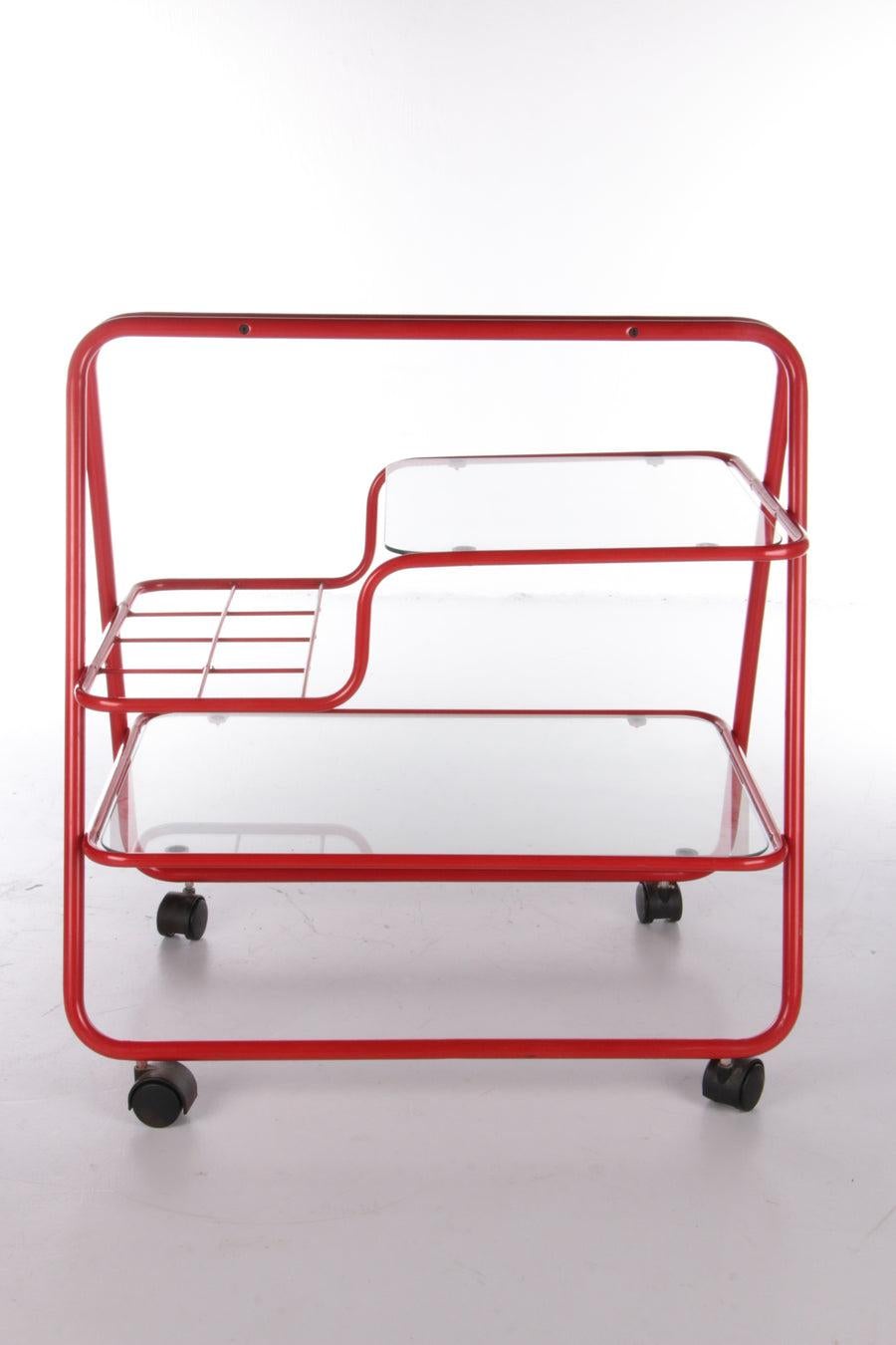 Vintage Red Metal Unique Trolley or Bar Cart, 1970s

Intage red metal unique trolley or bar cart, 1970s

This is a beautiful trolley from the 1970s.

The bottom leaf is made of glass and the top leaf is also glass, the frame is made of beautiful red