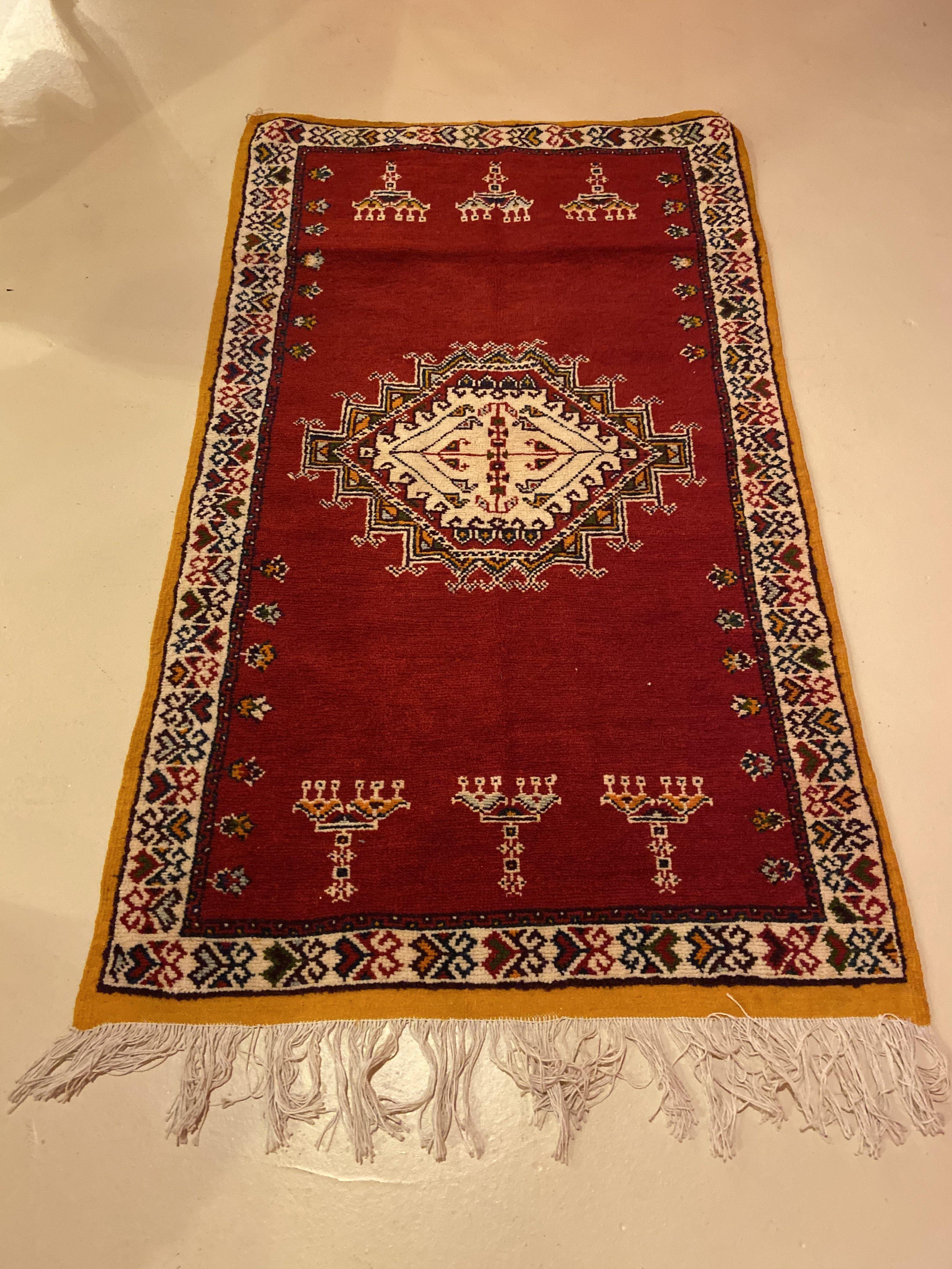 A stunning handwoven vintage Moroccan rug or carpet in a deep red color. The rug features captivating geometrical and berber abstract symbols. The rug is handwoven of pure sheep wool and and all natural vegetables dyes.
The rug is a sophisticated