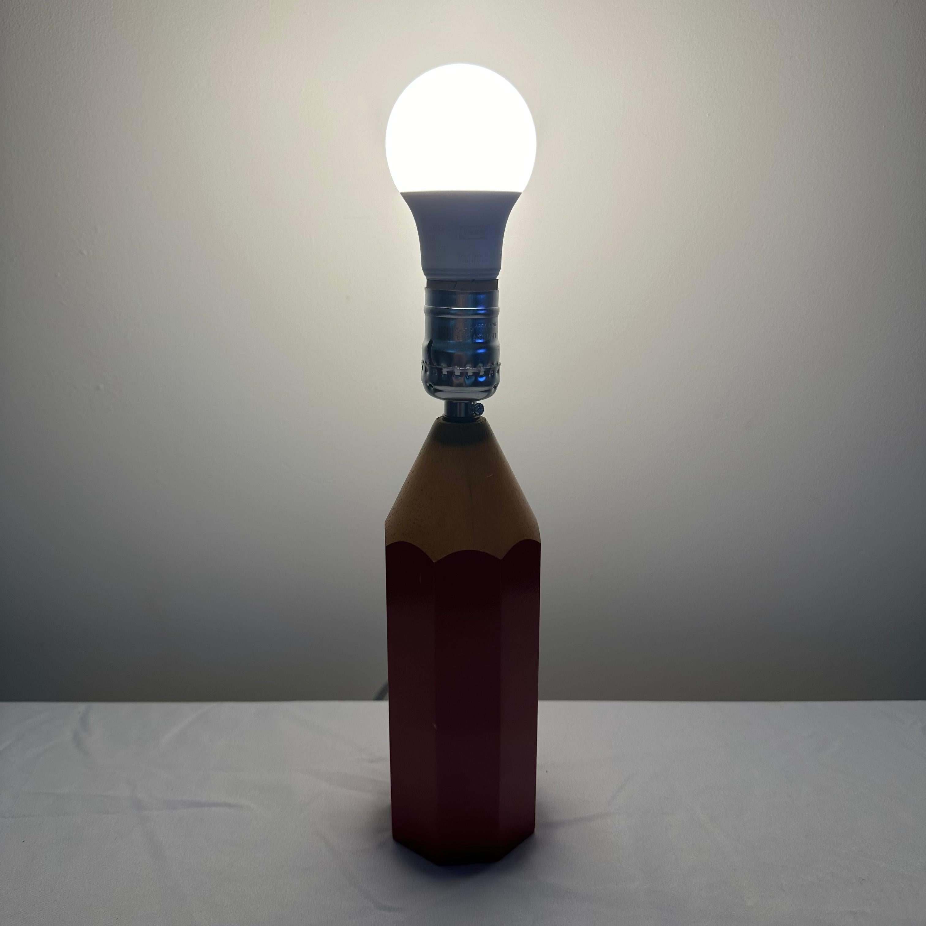 Vintage Red Pencil Table Lamp Pop Art Style, 1980s. This table lamp, in the form of an oversized pencil, is representative of the 1980s trend of making large versions of everyday objects. Octagon in shape, this playful, kitschy lamp is a striking