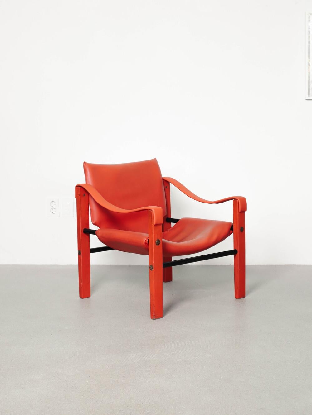 Beautiful vibrant red Safari arm chair by Maurice Burke for Arkana.  