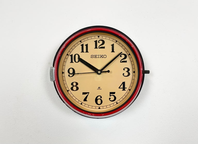 Vintage Seiko navy slave clock designed during the 1970s and produced till 1990s. These clocks were used on large Japanese tankers and cargo ships. It features a red metal frame, a plastic dial and clear glass cover. This item has been converted