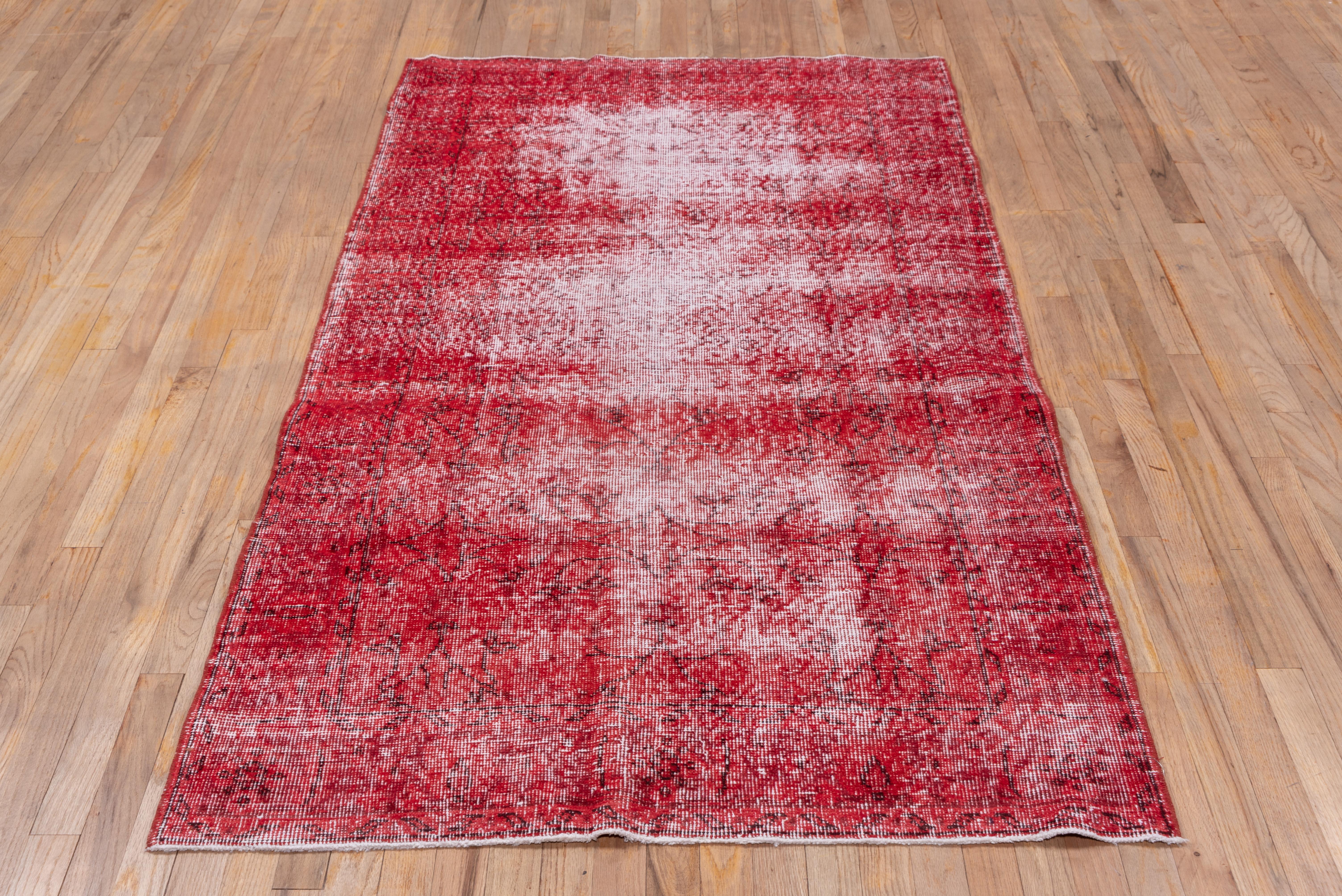 This red shabby chic Turkish overdyed Sparta carpet has a pattern defined by the wear beyond the all-over general distress. Vertical and horizontal off white strips cross near the center. Shabby chic conditions and can offer some great texture for
