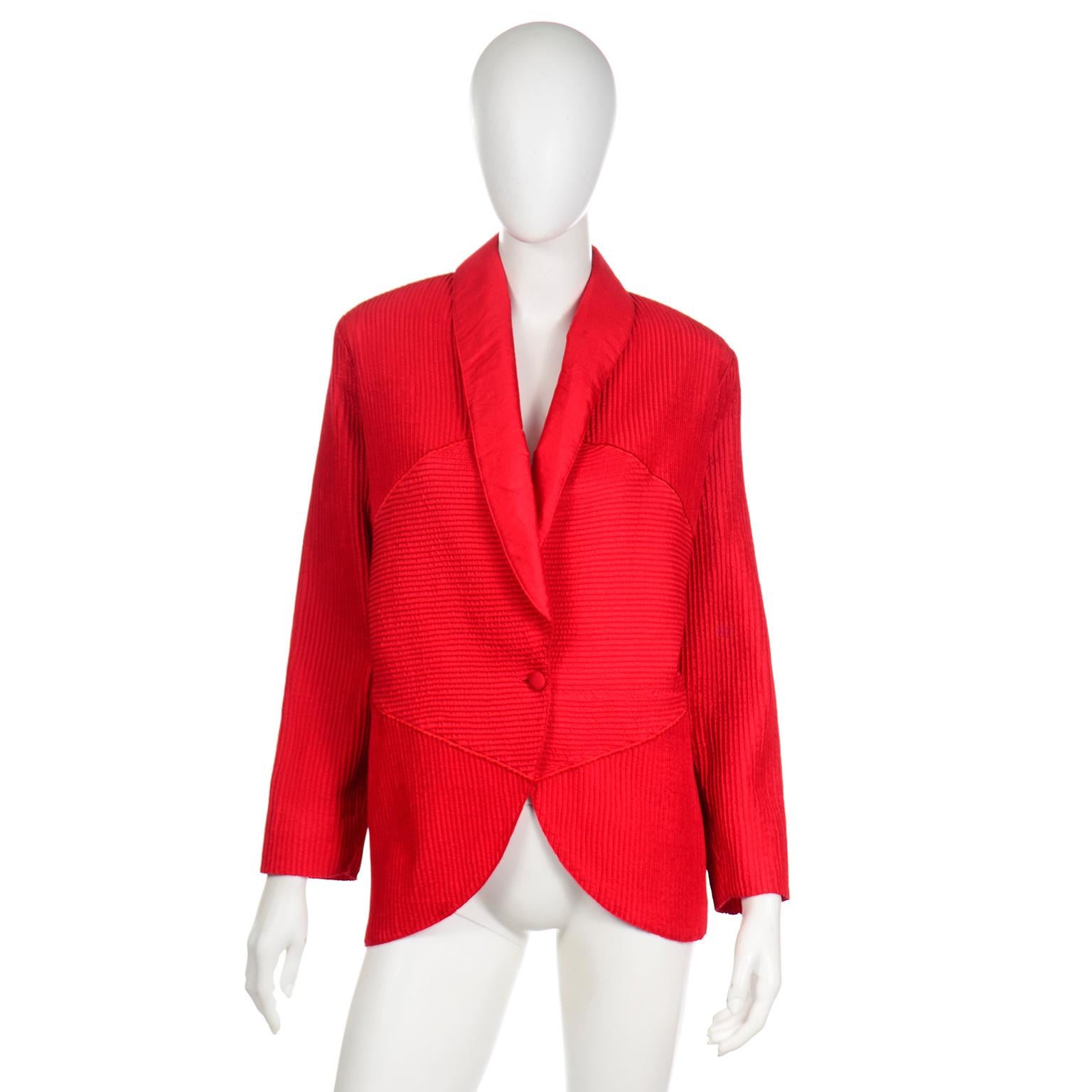 This is a fabulous red topstitched textured silk avant garde jacket custom made in Thailand. This jacket has a narrow hip fit with a wider upper body. There is a very unique striped effect done to the silk with the use of vertical and horizontal