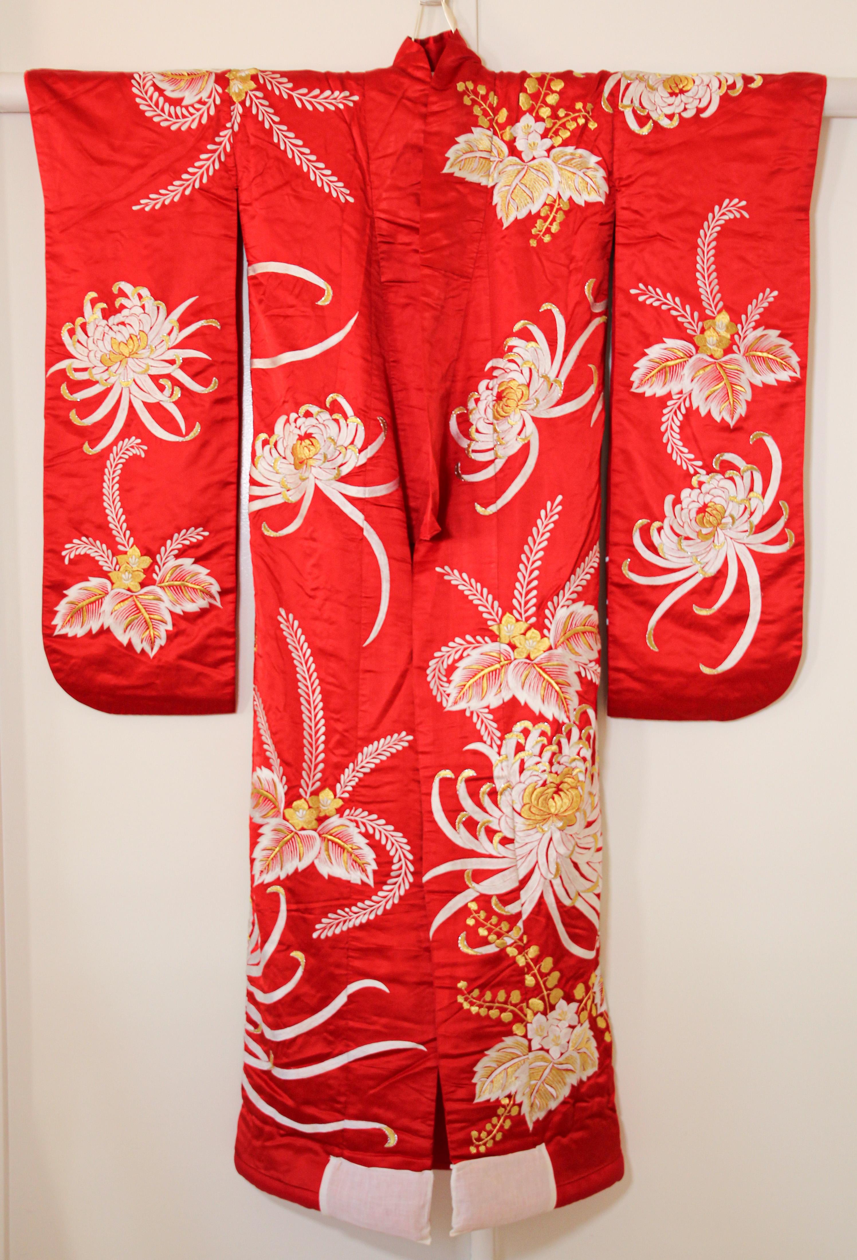 A vintage midcentury red color silk brocade collectable Japanese ceremonial wedding kimono. 
One of a kind handcrafted .
Fabulous museum quality ceremonial piece in pure silk with intricate detailed hand-embroidery throughout accented with gold