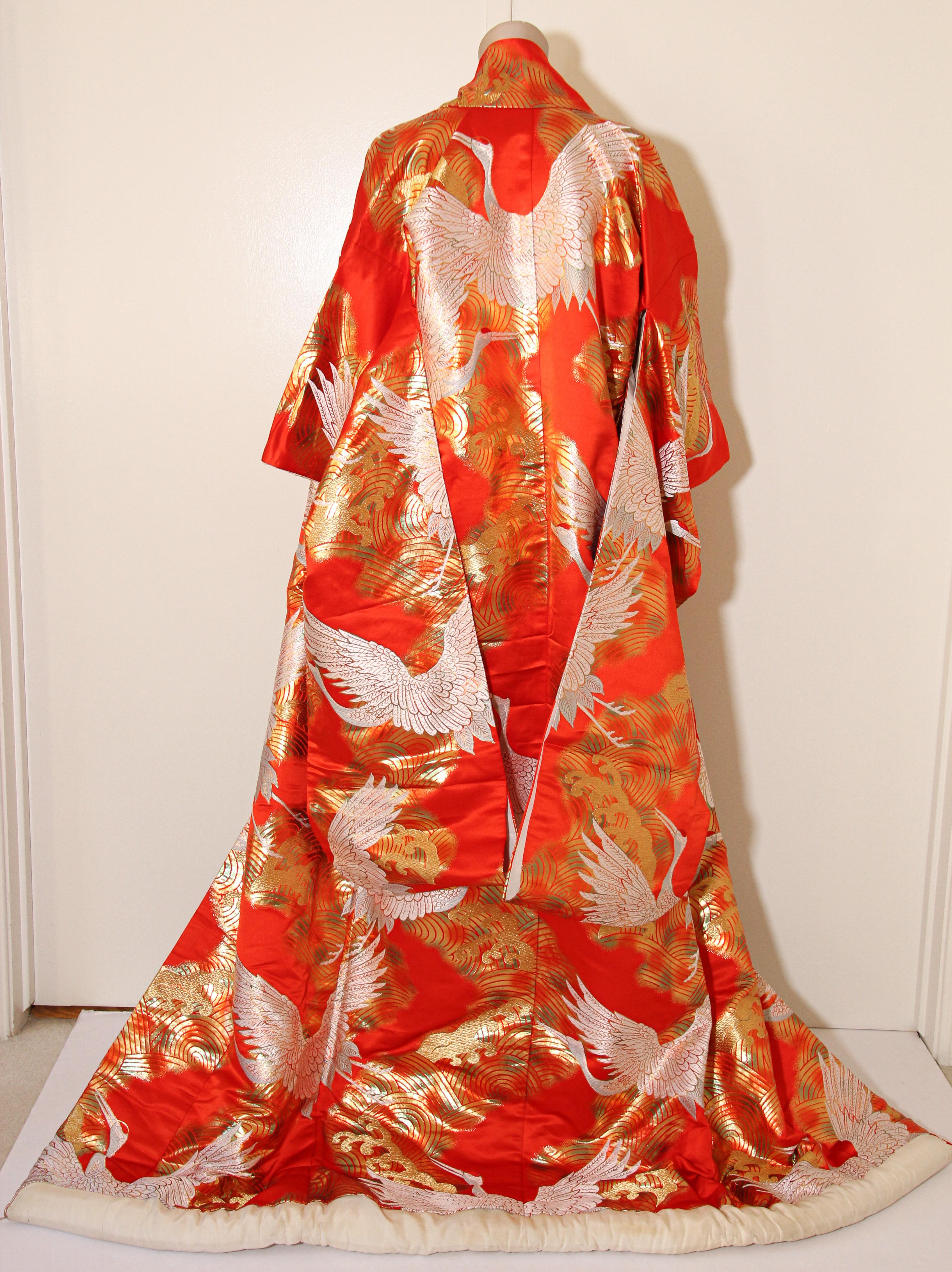 A vintage midcentury red color silk brocade collectable Japanese ceremonial wedding kimono. 
One of a kind handcrafted.
Fabulous museum quality ceremonial piece in pure silk with intricate detailed hand-embroidery throughout accented with gold