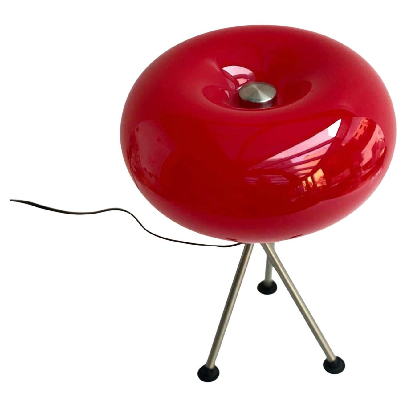 Vintage red table lamp. 

Germany, 1970s. 

Chromed metal tripod base made of 3 rods with plastic revolving caps. Chrome round plate with air-holes. Round UFO style red oval glass globe lampshade with a chrome round cap.

The design of the