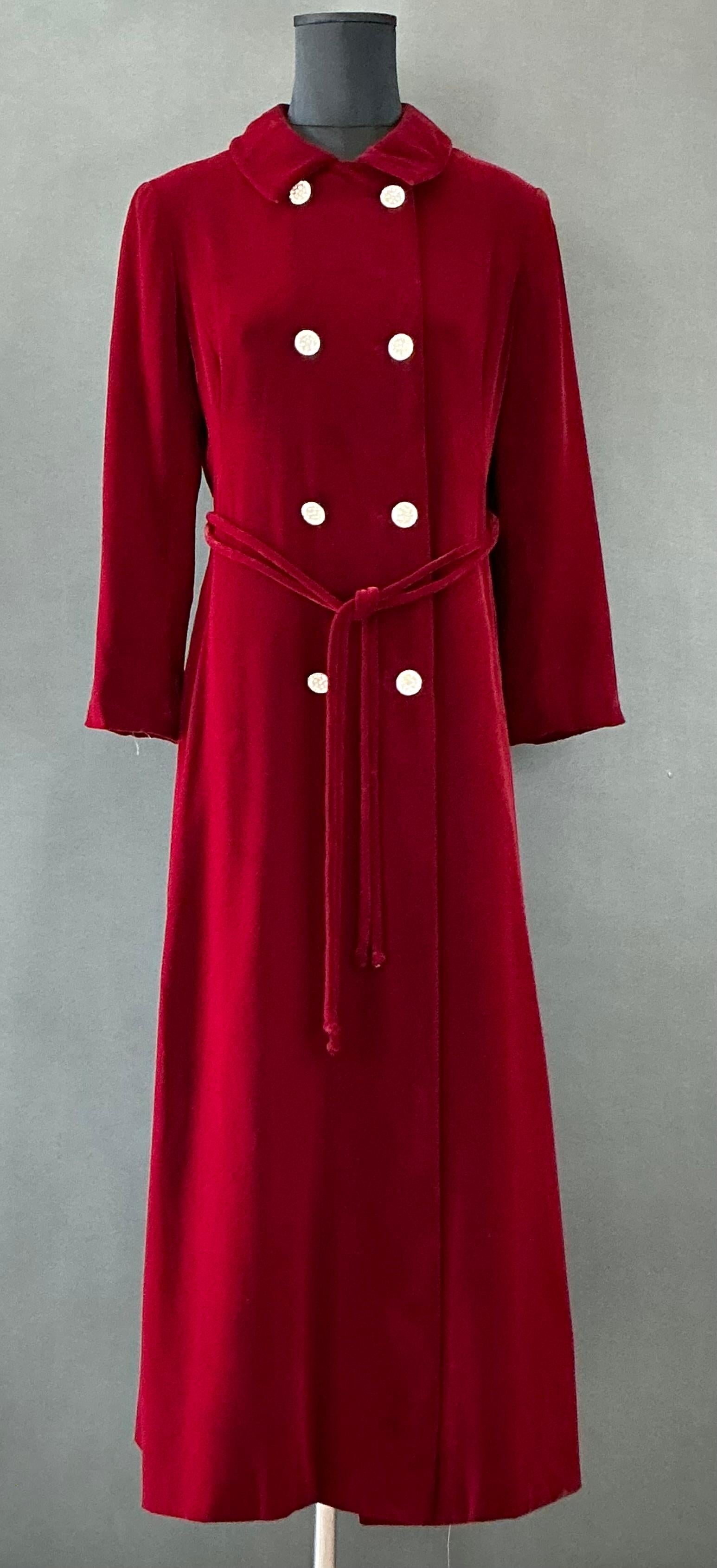 This Vintage Red Velvet Overcoat is a statement piece that exudes luxury, warmth, and timeless elegance. Known for its rich texture and regal color, velvet is a fabric that has been associated with opulence and sophistication for centuries. A red