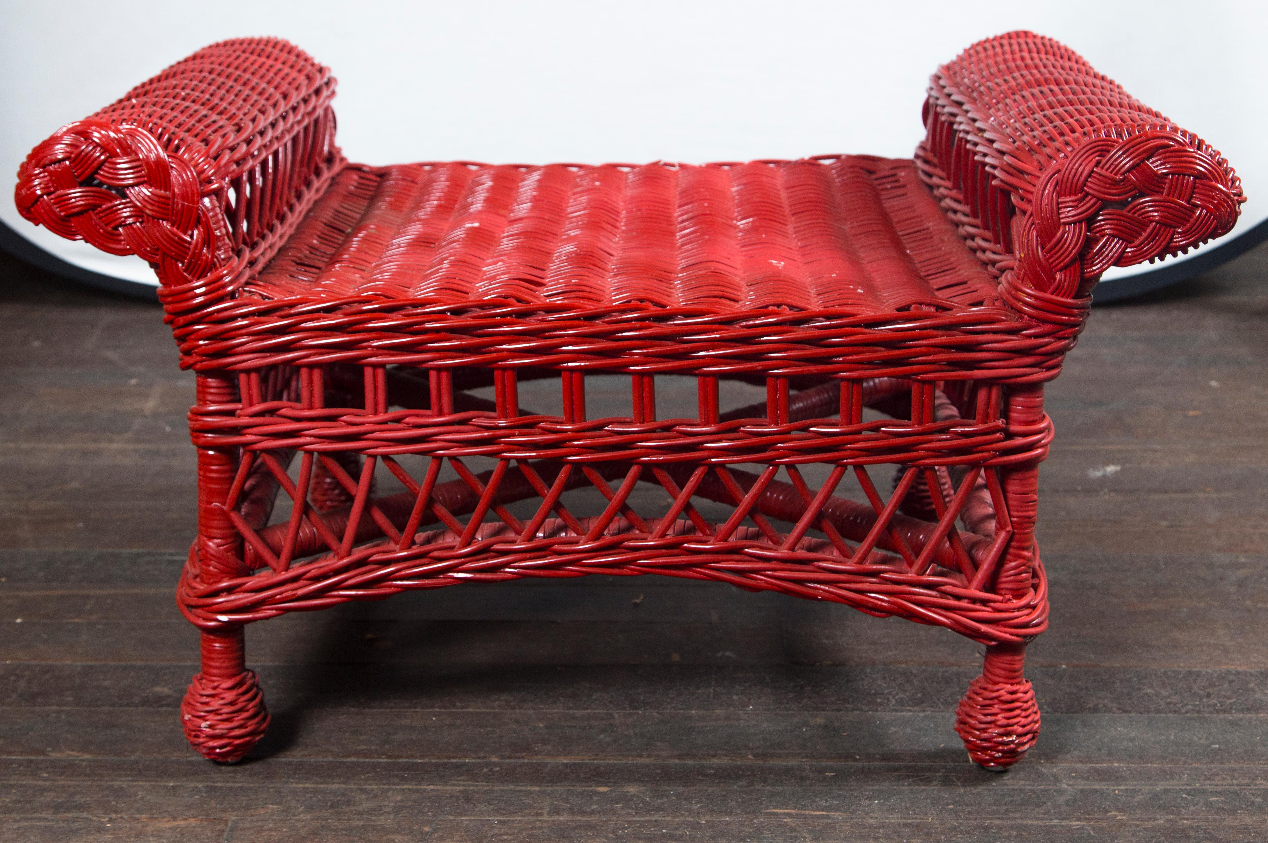 Sturdy, well-made, vintage wicker bench painted red.