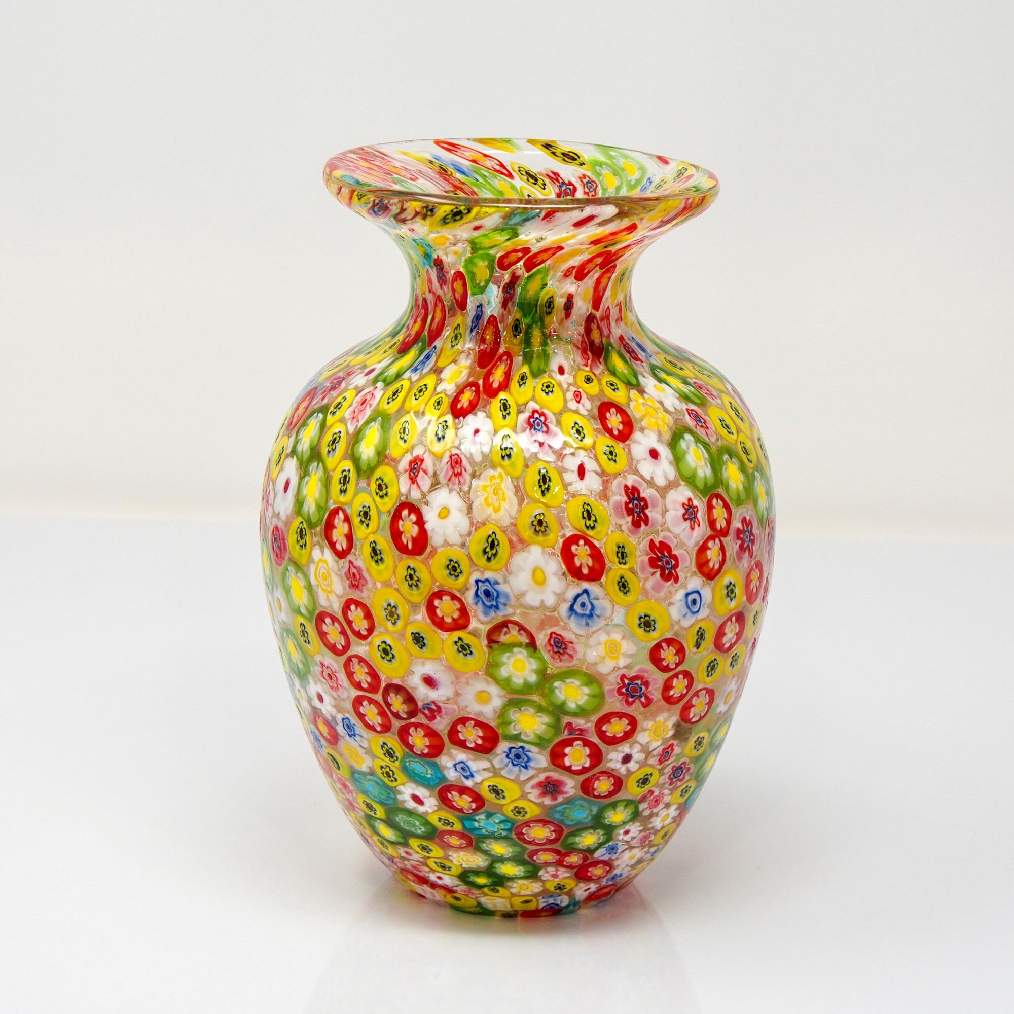 Circa 1970s Murano glass millefiori vase in shades of yellow, green and red. Medium size at 8.5” tall with classic shape. No signature found. 

Very good vintage condition with very minor scattered surface wear but no chips, cracks, flakes or