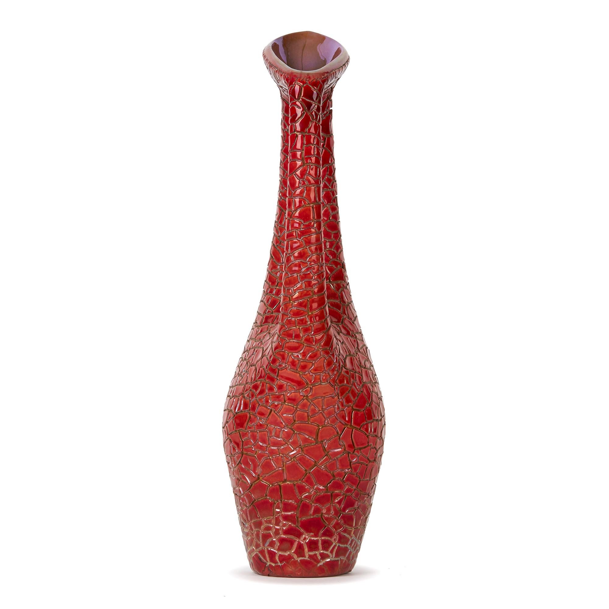 PLEASE NOTE: This piece is currently located in our Amsterdam office, please enquire for delivery times. 

A stylish midcentury handled jug-vase the body in a scaled finish and decorated in flambe red eosin glazes. This stunning example was designed