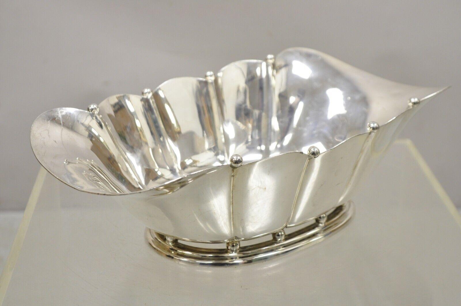 Vintage reed & barton silver plated scalloped fluted large fruit bowl dish. Item features a shapely fluted form, ball form accents, base raised on ball form feet, marked 
