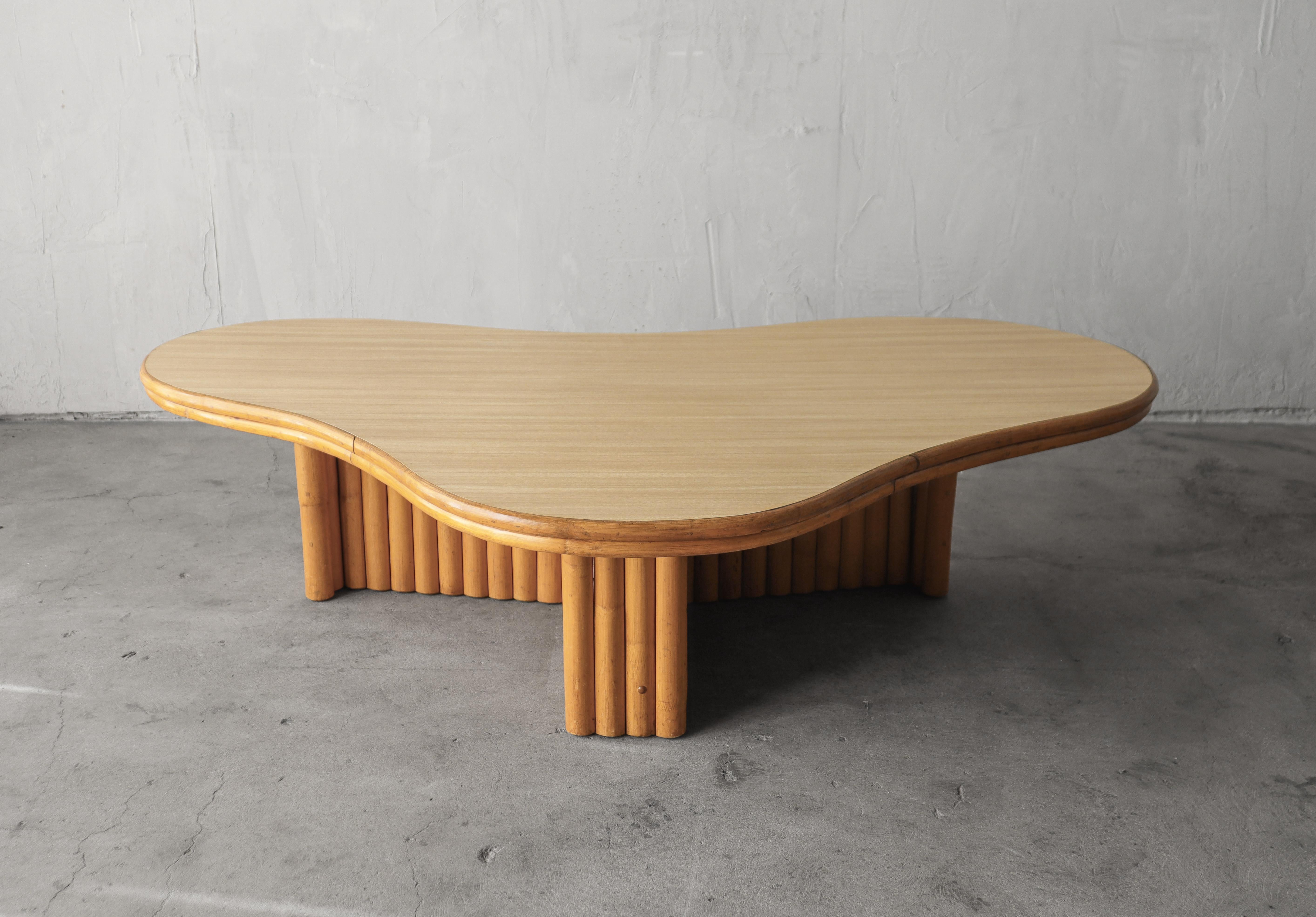 Incredible vintage biomorphic bamboo coffee table attributed to Paul Frankl.

Top is ever durable light wood laminate. 

Table is in great vintage condition overall with the top having a couple tiny dings and some minimal wear to the bamboo.

      