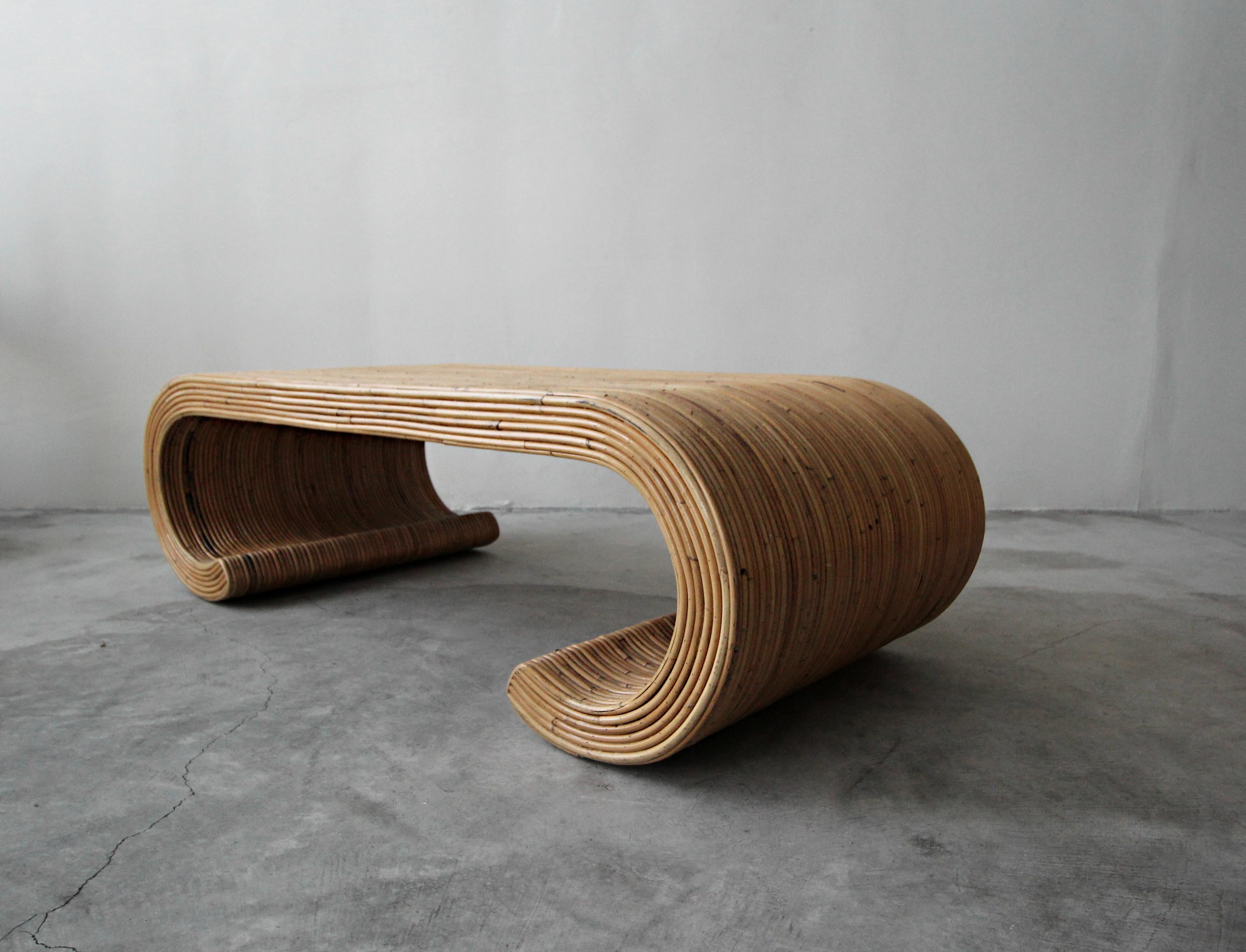 Rare vintage, reeded bamboo coffee table with scroll edge. If you love furniture with this style and feel this beauty is for you. 

Coffee table is in excellent condition with no damage to be noted.