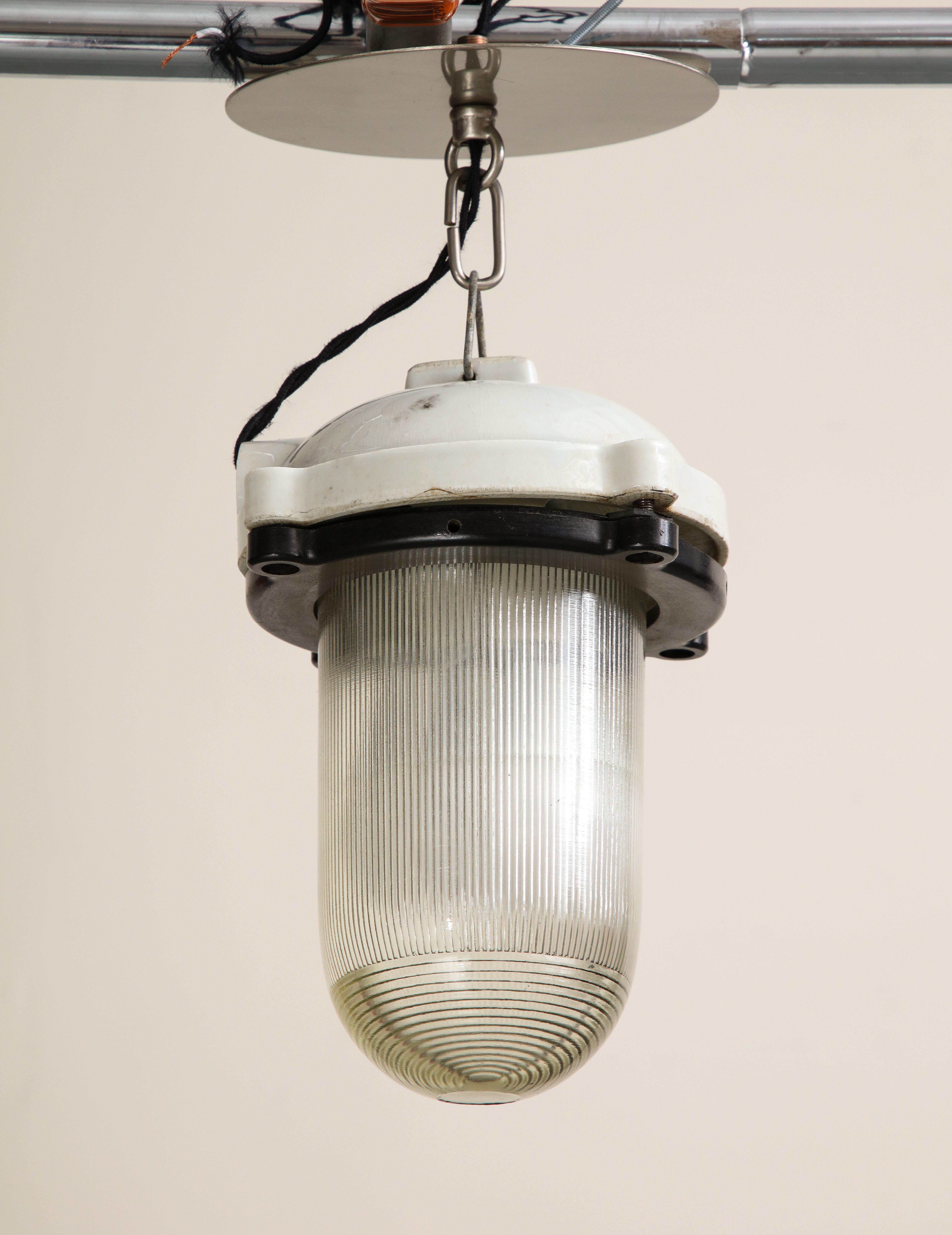Vintage industrial pendant with reeded glass and white enamel cast iron top, mid 20th century. Wired for USA, good working condition. 