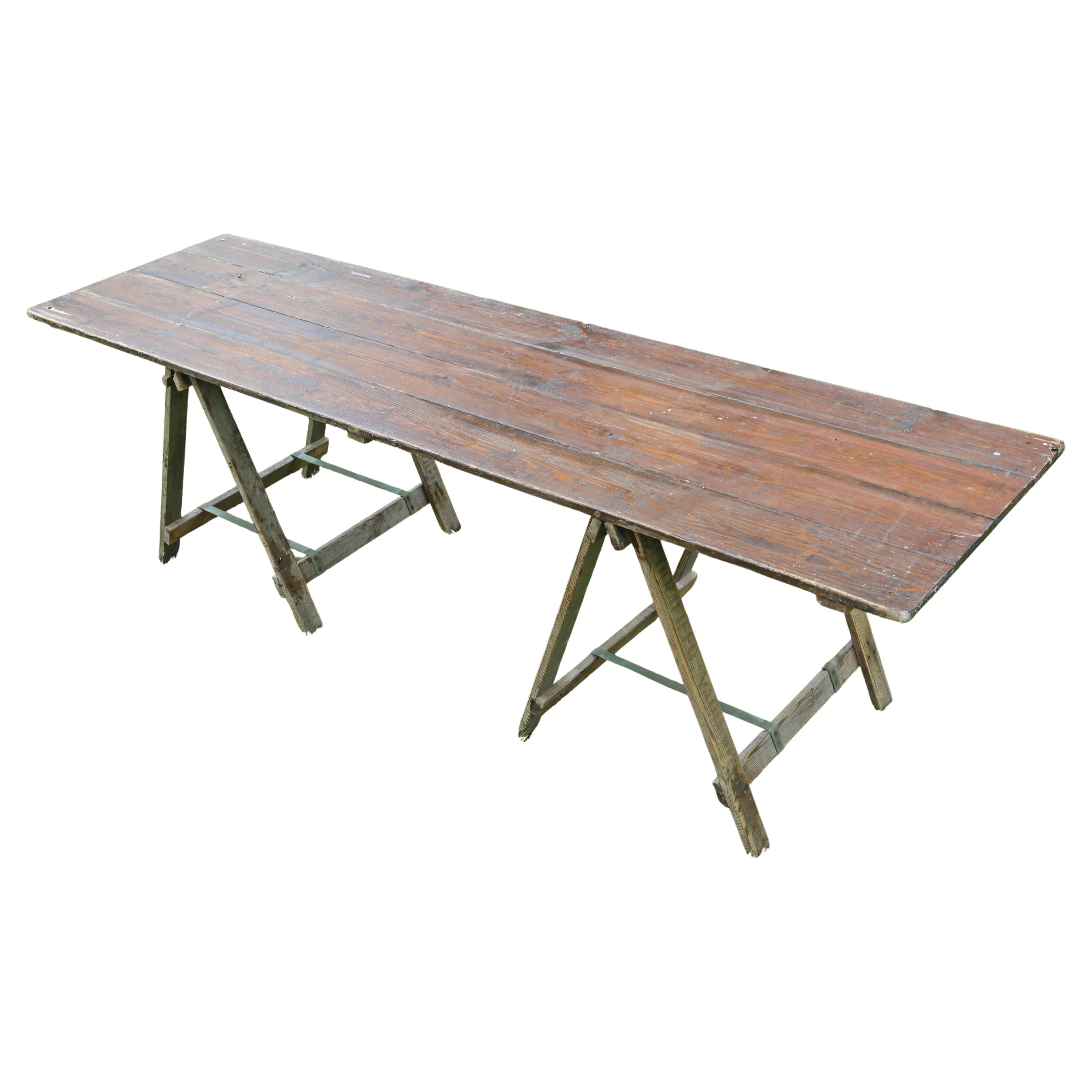 Antique vintage trestle refectory kitchen, garden or dining table.

Dates from the mid 20th Century. Procured from a marquee company, who specialised in vintage weddings.

Solid, with no loose joints and in good working order. Top lifts off and
