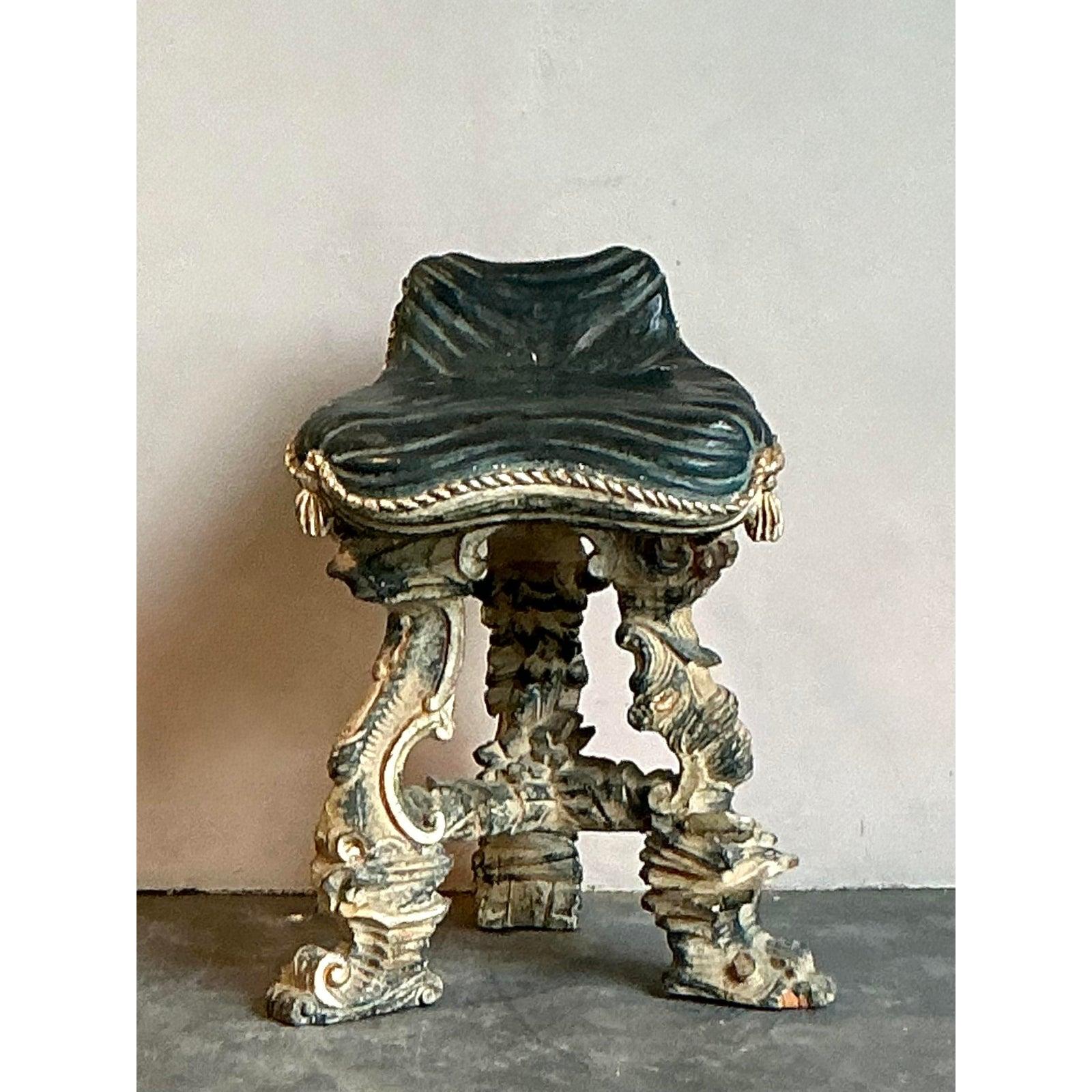 Elevate your space with this captivating vintage low stool, a true statement piece that embodies the opulence of the Renaissance Revival. Crafted in the early 20th century, this piece is a testament to meticulous craftsmanship, featuring an