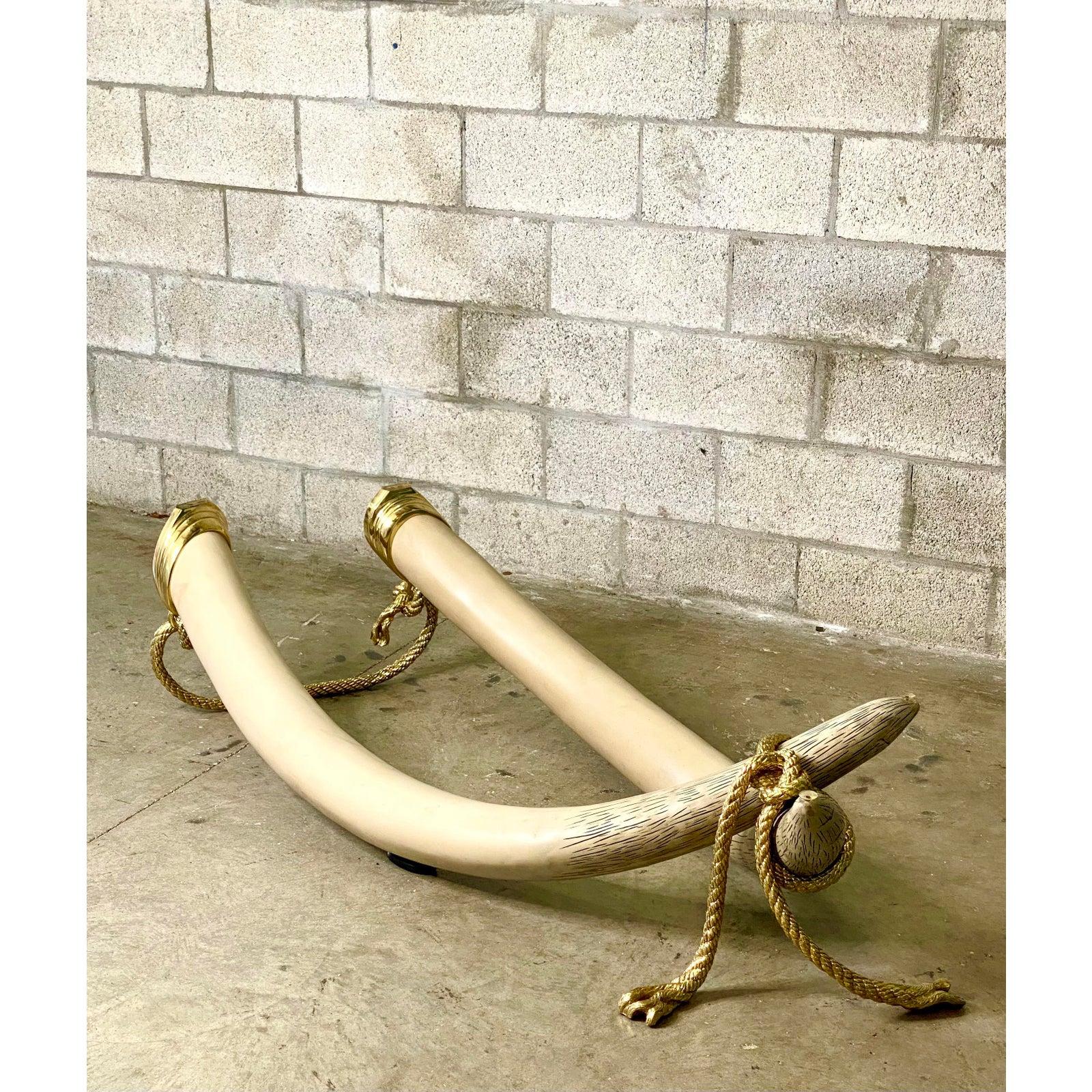 Spectacular 1970s Italo Valenti Brass and glass coffee table. Chic faux elephant tusks wrapped in a brass rope. The original brass rimmed glass top. Stamped on the brass. A real collectors item.