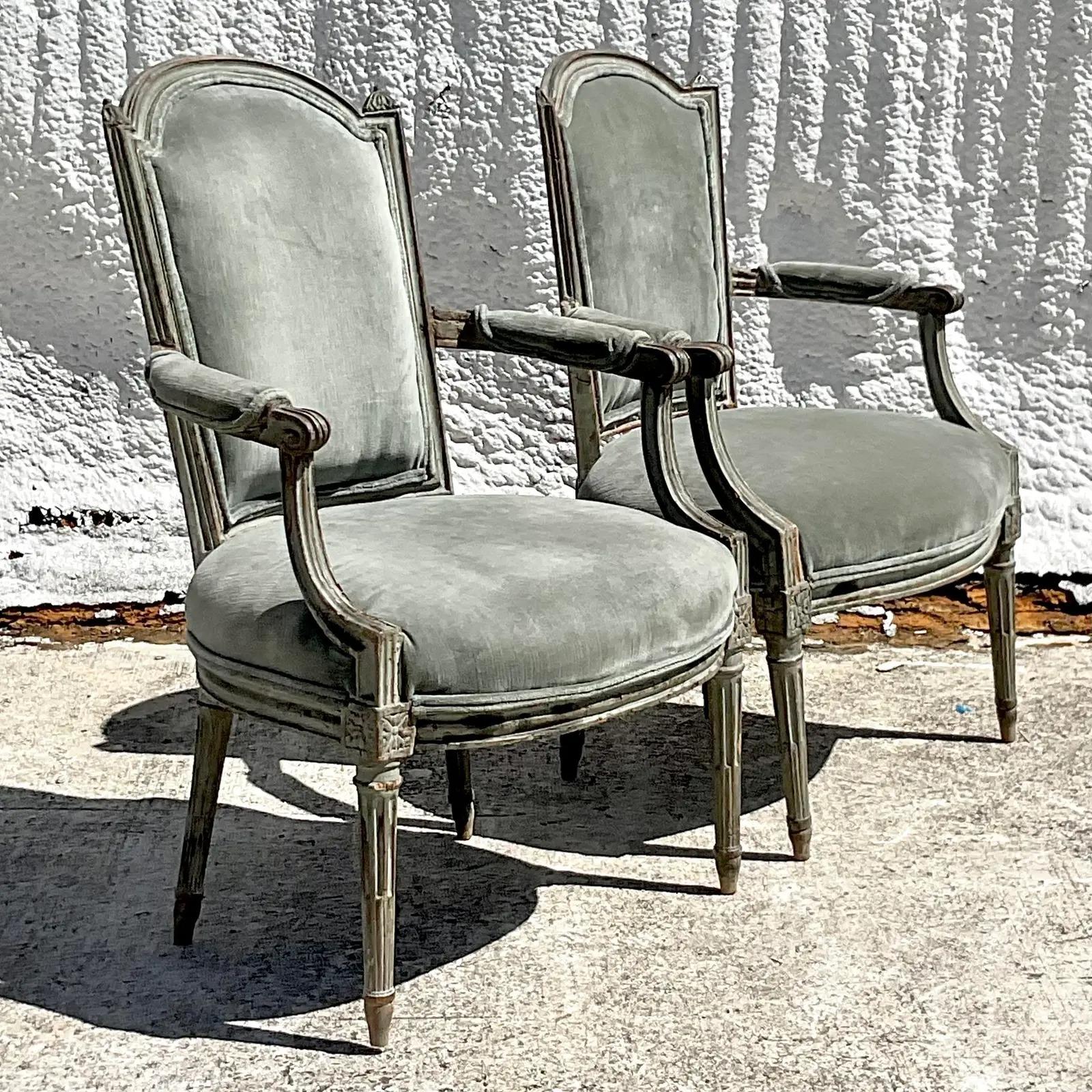 A fantastic set of two vintage Regency chairs. A chic set of 19th century Bergere chairs with amazing hand carved detail. Upholstered in a smoky grey velvet with double welting trim. Acquired from a Palm Beach estate.

The chairs are in great