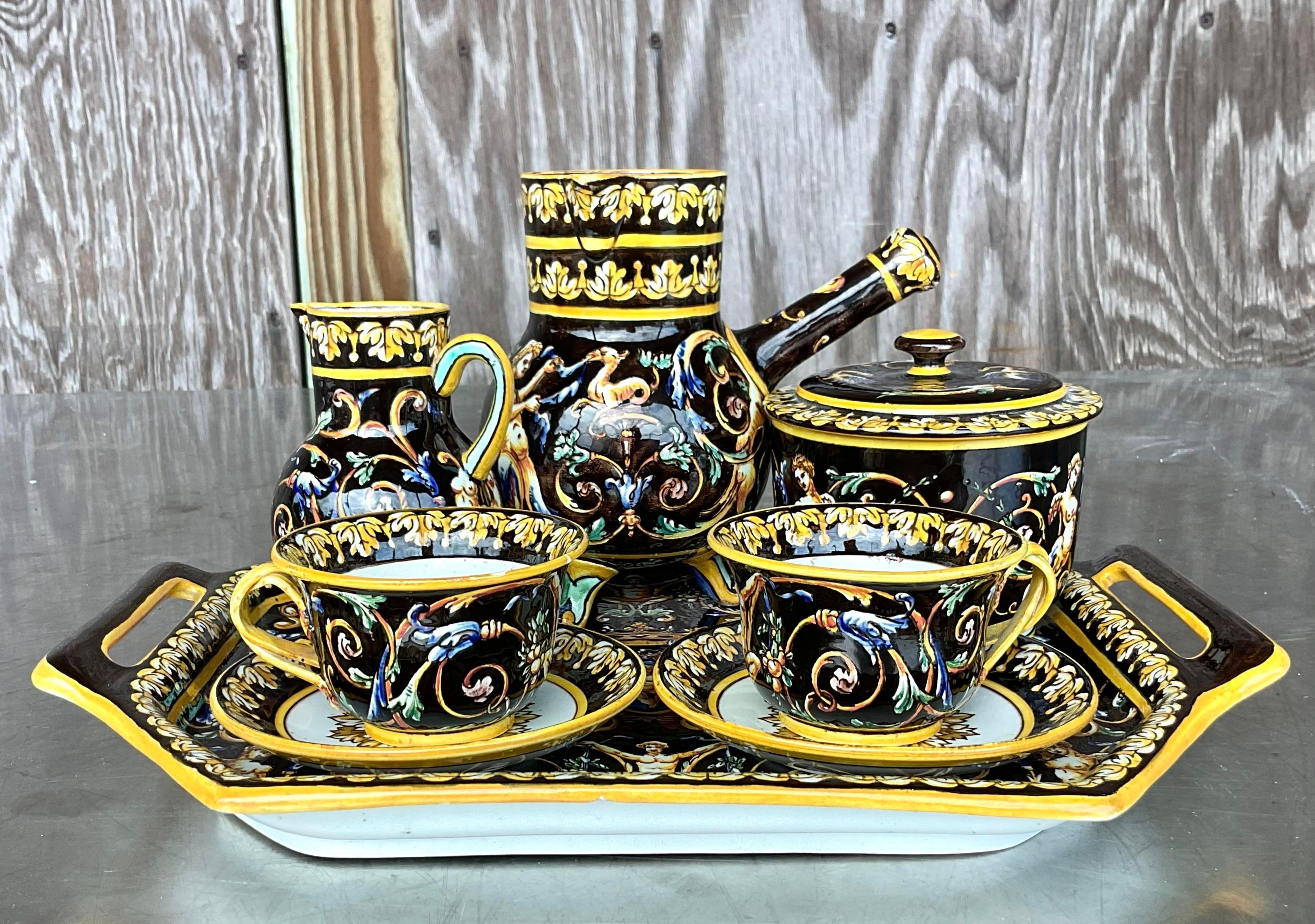 A stunning vintage Regency Chocolate set. Made by the coveted Gien group and marked on the bottom. A charming hand painted set open deep rich colors. Acquired from a Palm Beach estate.

Large pot - 5.5x3.5x5.5
Small pot - 3.5x 2.5x 4.5
Small lidded