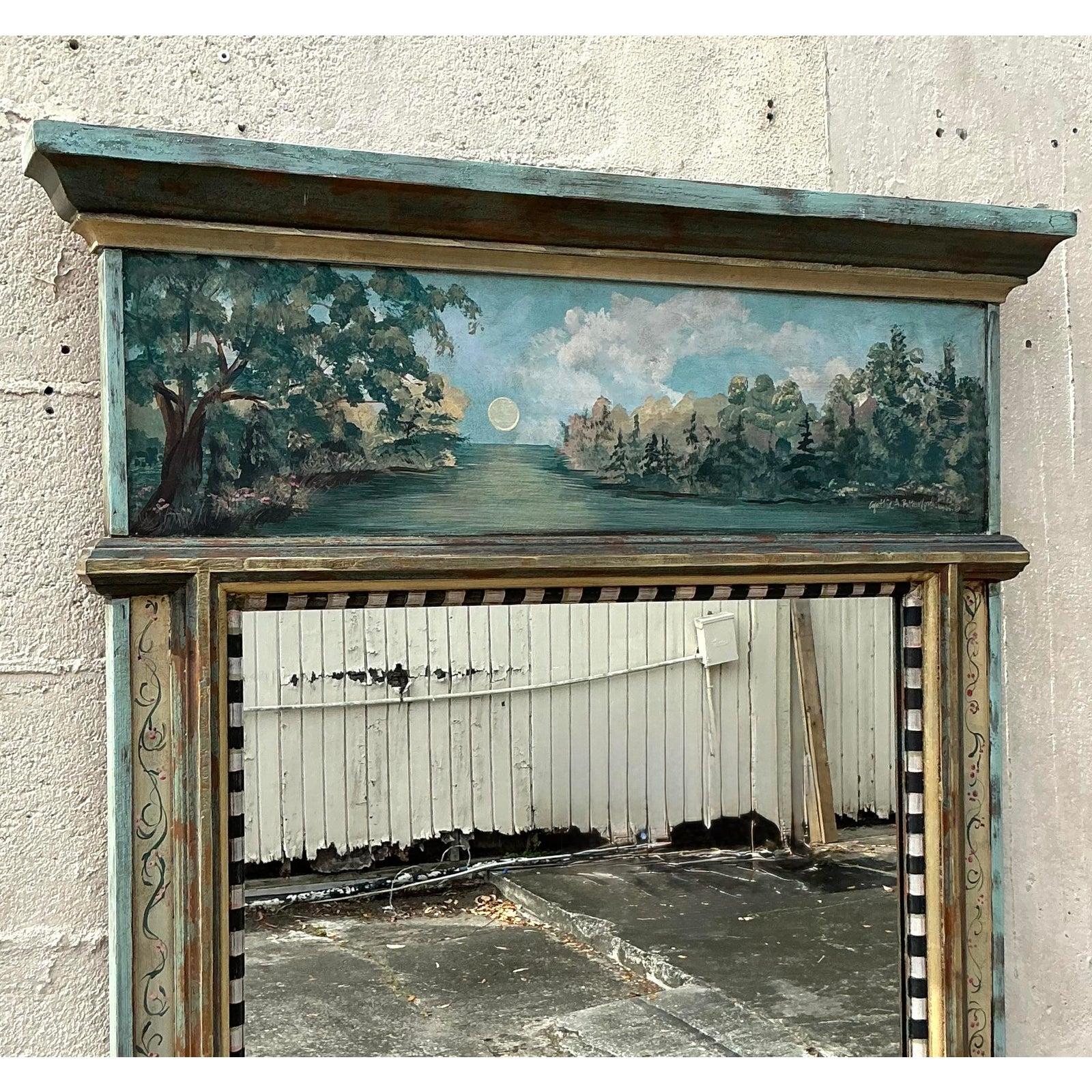Transform your wall into a captivating focal point with this extraordinary vintage mirror, distinguished by its impressive scale and unique artisan craftsmanship. The substantial frame is crowned with a beautifully hand-painted landscape panel,
