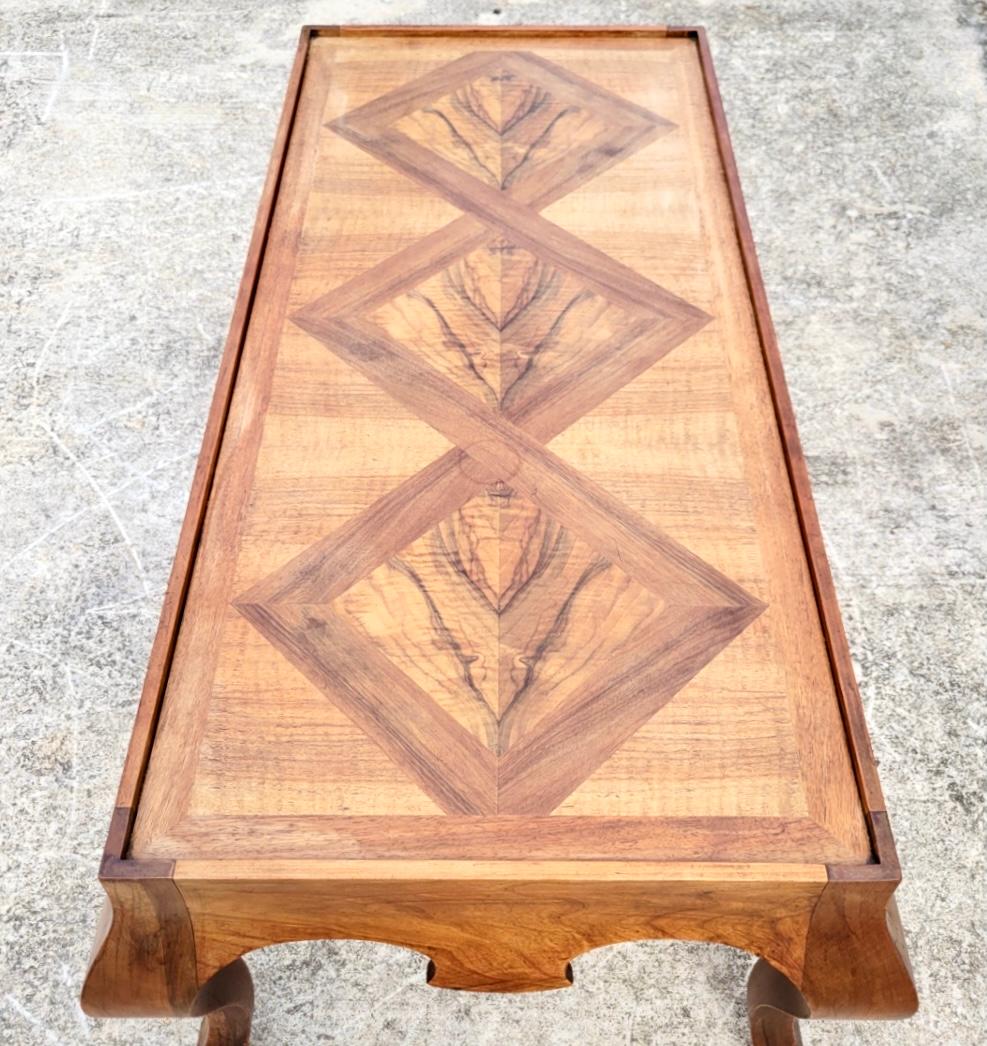 Stunning vintage Regency Baker coffee table. Beuatiful Olive burl wood in a chic diamond design. Cabriolet legs with scroll mill work along the edge. A real showstopper. Acquired from a Palm Beach estate.