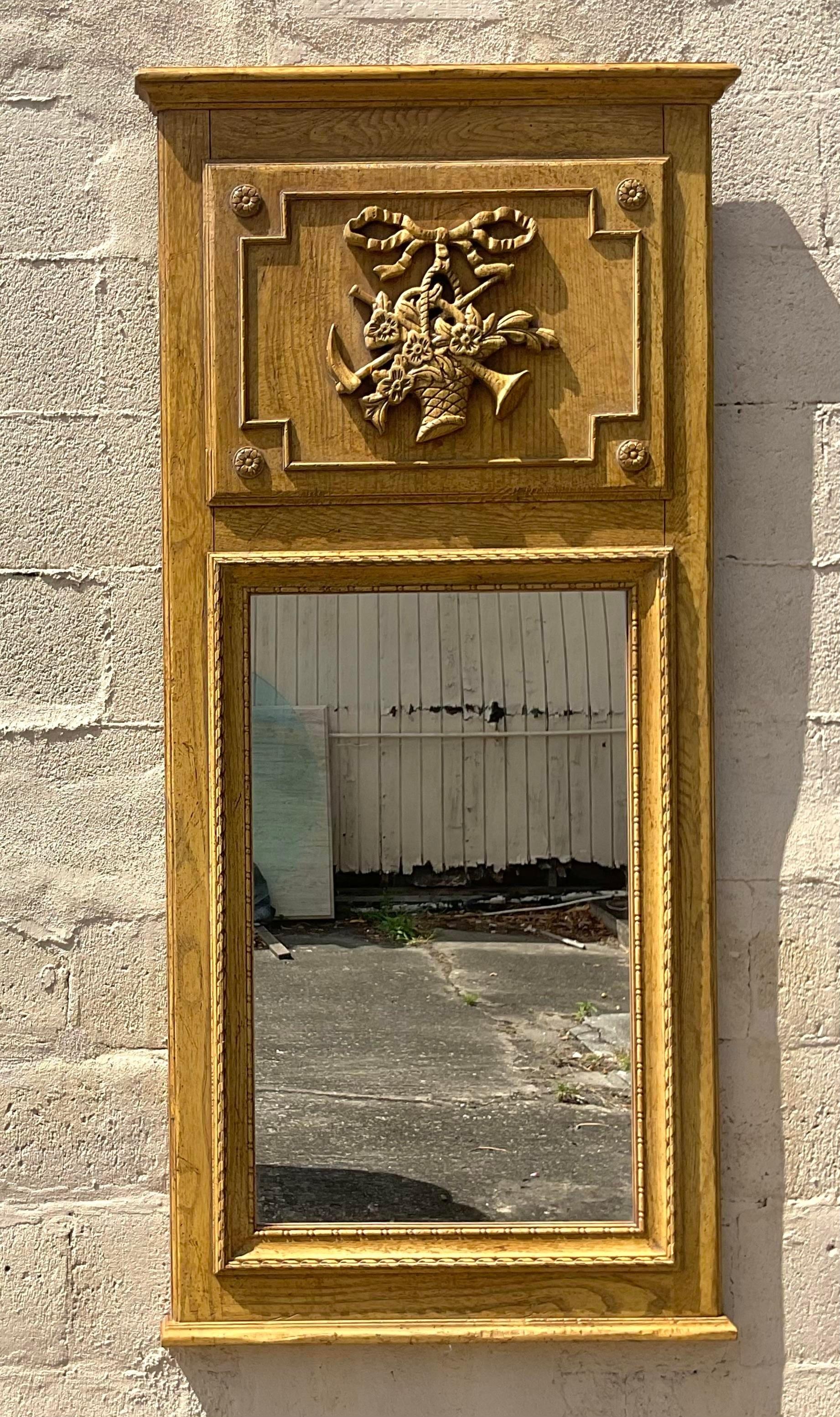 Add a touch of classic elegance with this Vintage Regency Baker trumeau mirror. Reflecting American Regency style at its finest, this mirror showcases exquisite craftsmanship and timeless design. A sophisticated accent piece that elevates any room