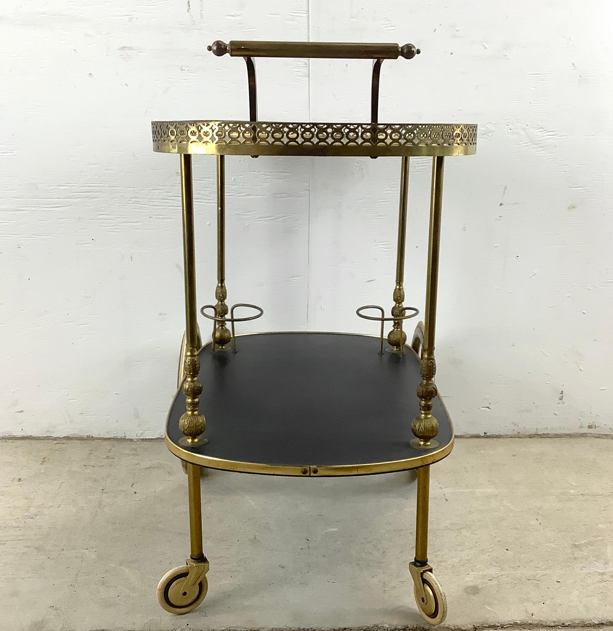 Elevate your home with this ornate, vintage tea cart, reminiscent of lavish afternoons and refined hospitality. This enchanting serving cart, resplendent in its golden hues and detailed decorative tray, exudes the charm of the high tea elegance of