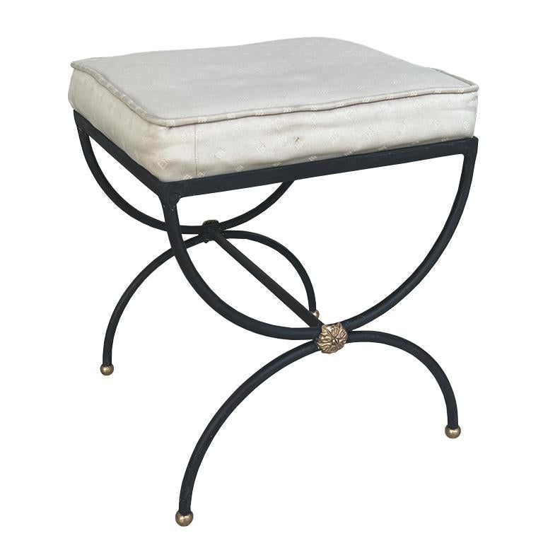 A beautiful black and gold iron carule bench in the manner of Salterini. This sturdy Hollywood Regency bench will be a fabulous vanity seat or extra seat in a formal living. (We particularly love the idea of it next to a fireplace.) The top is