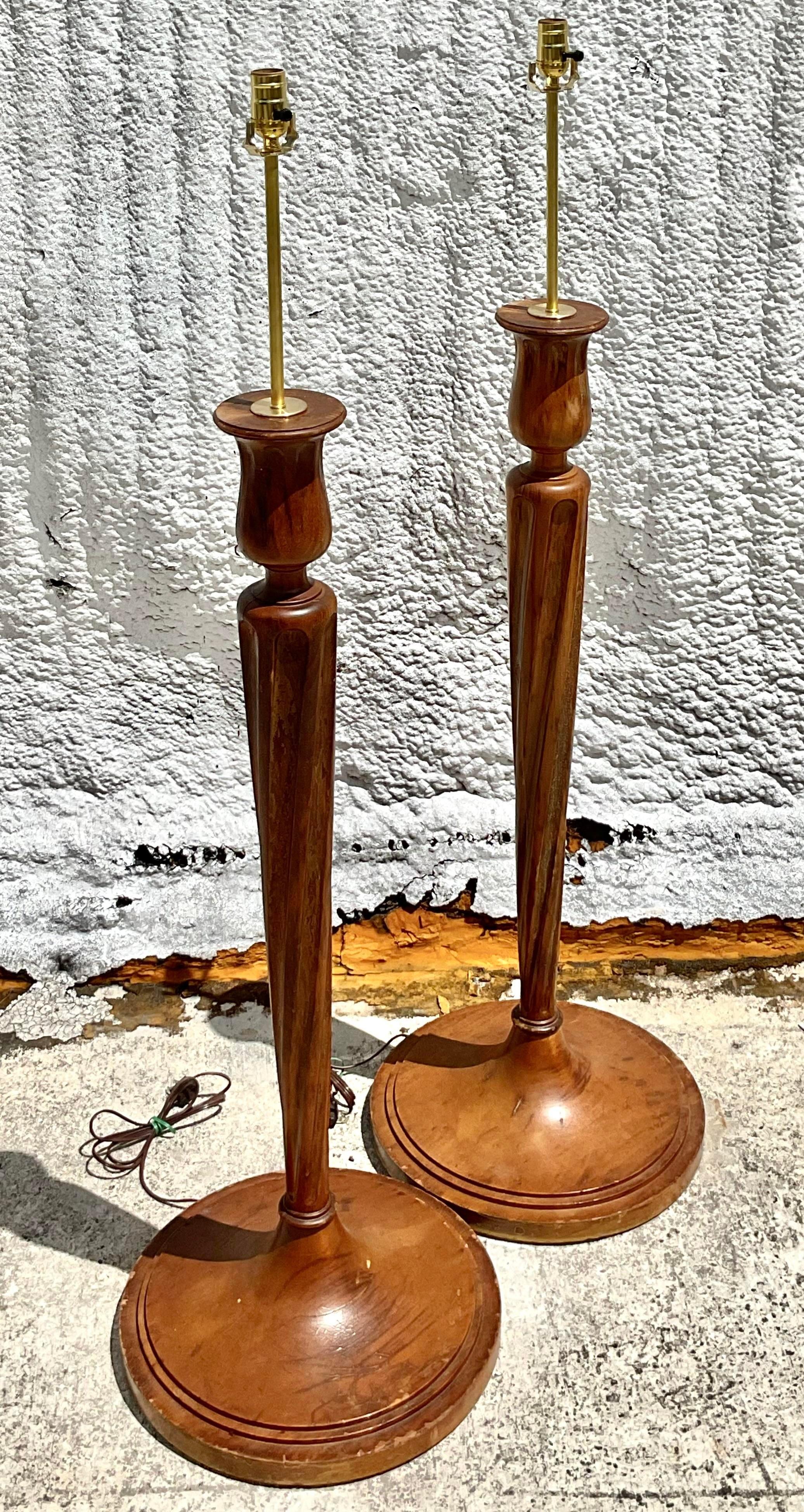 A fabulous pair of vintage Regency wood floor lamps. Beautiful classic candlestick design. Fully restored with all new wiring and hardware. Acquired from a Palm Beach estate.
