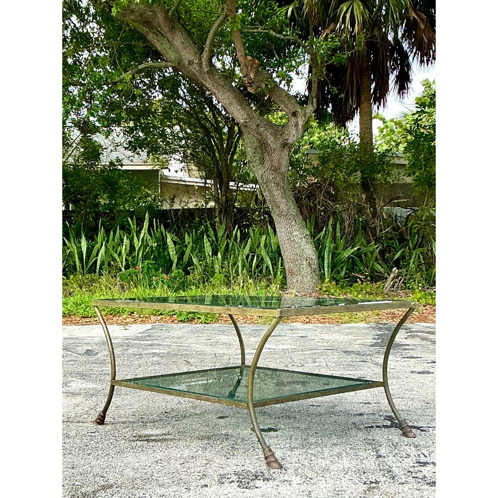 Cette table basse en sabot de laiton Vintage Regency dégage une élégance intemporelle avec son design sophistiqué et ses détails raffinés. Le cadre en laiton massif présente des pieds gracieusement incurvés qui se terminent par des pieds en sabot